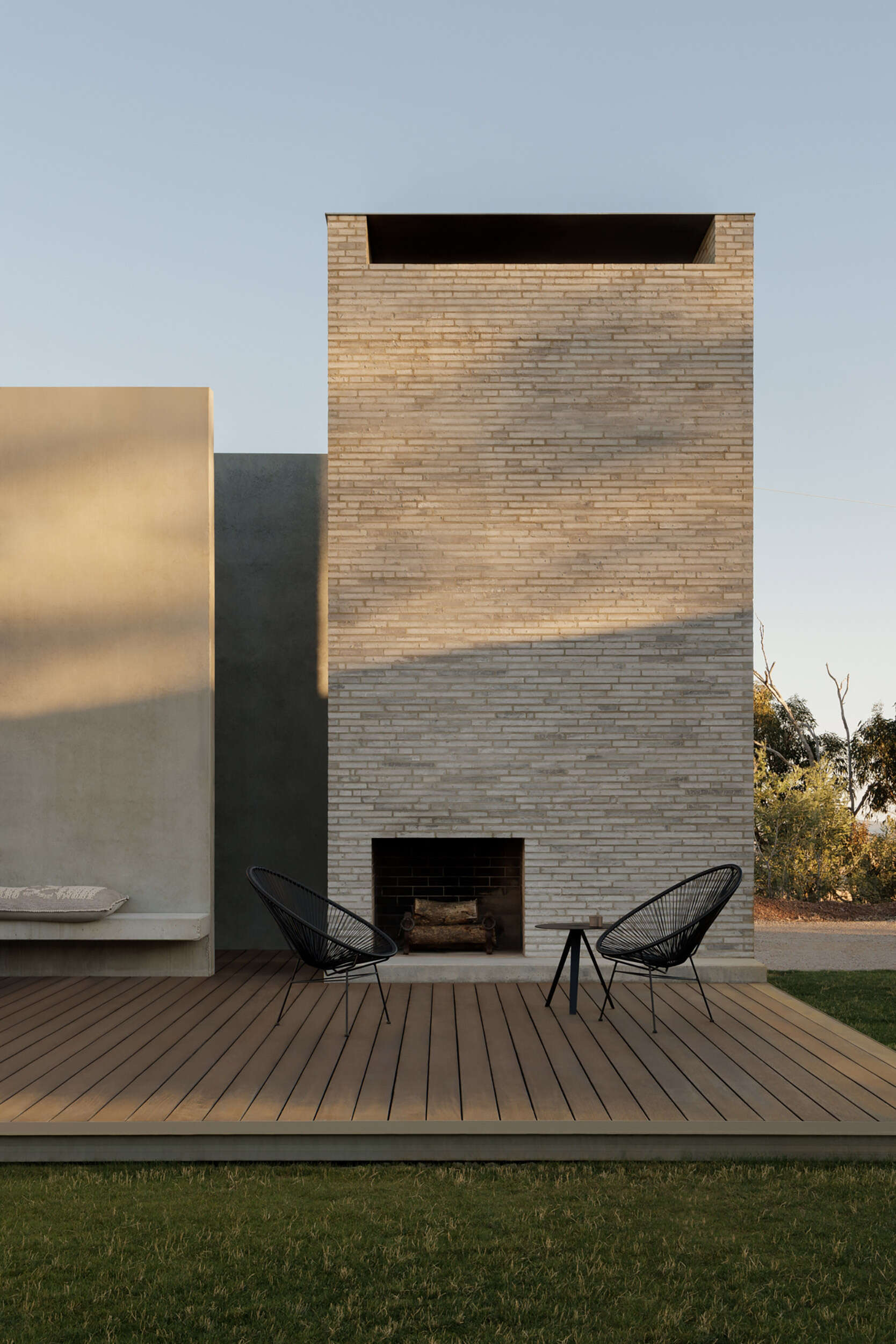 Informal plantings, large boulders, an outdoor fireplace, and a BBQ area transform the central courtyard into an inviting outdoor living space.