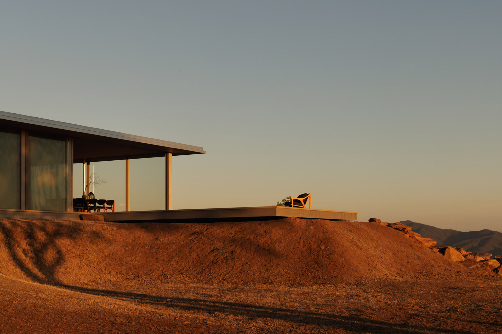 This elevated terrace projects into the landscape, offering panoramic views that stretch across the surrounding countryside and mountains.