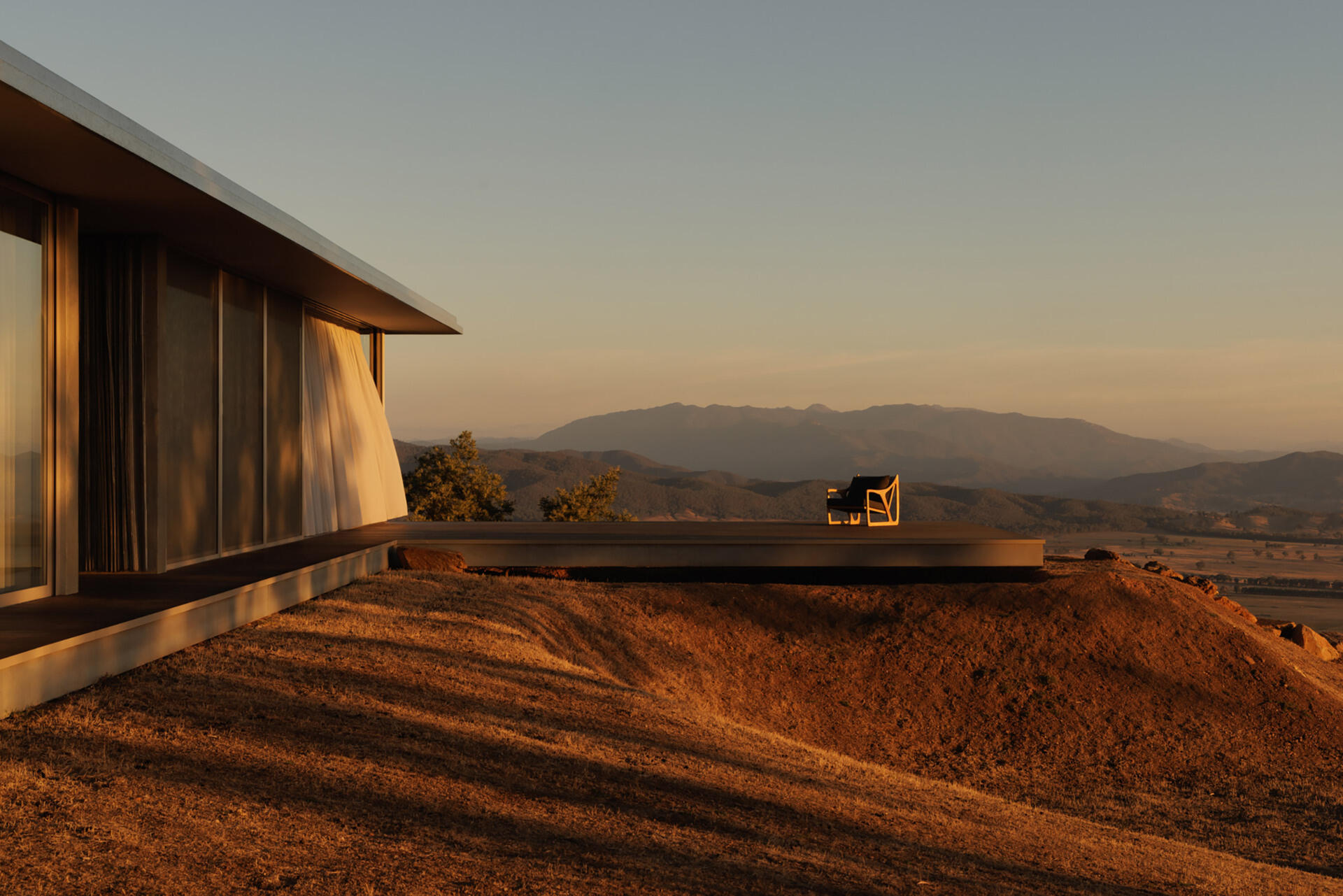 This elevated terrace projects into the landscape, offering panoramic views that stretch across the surrounding countryside and mountains.