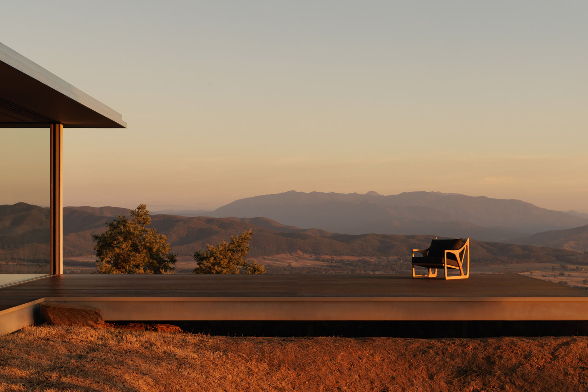 This elevated terrace projects into the landscape, offering panoramic views that stretch across the surrounding countryside and mountains.