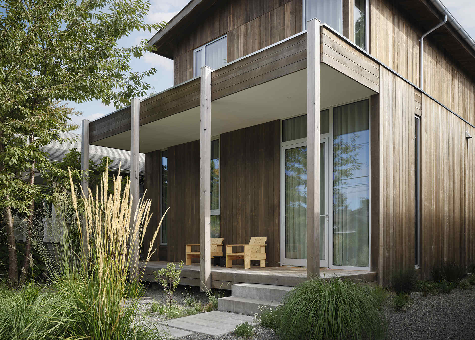 Natural cedar siding, native landscaping, and a simple gabled roof give this Seattle home a timeless Pacific Northwest character.