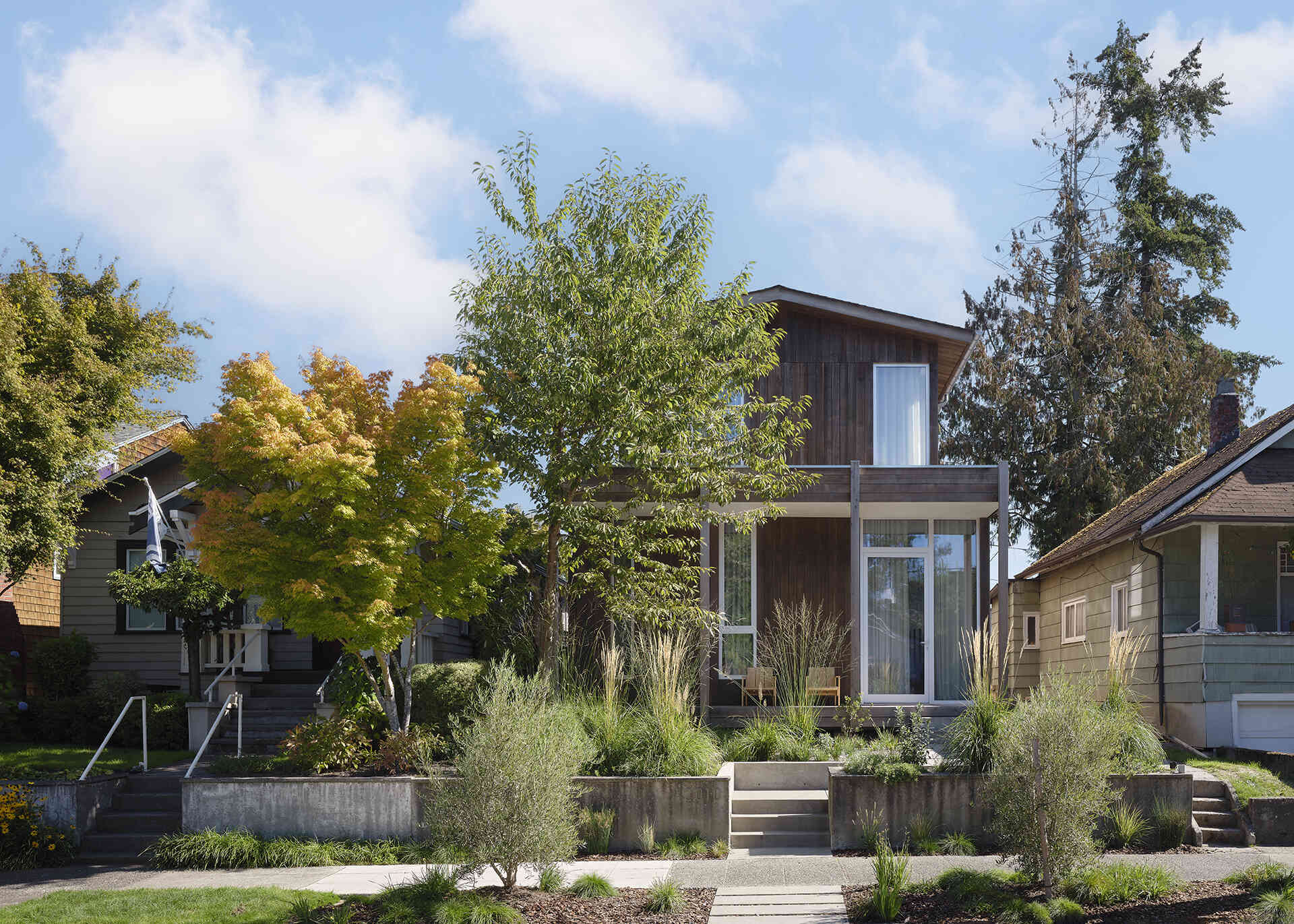 Natural cedar siding, native landscaping, and a simple gabled roof give this Seattle home a timeless Pacific Northwest character.