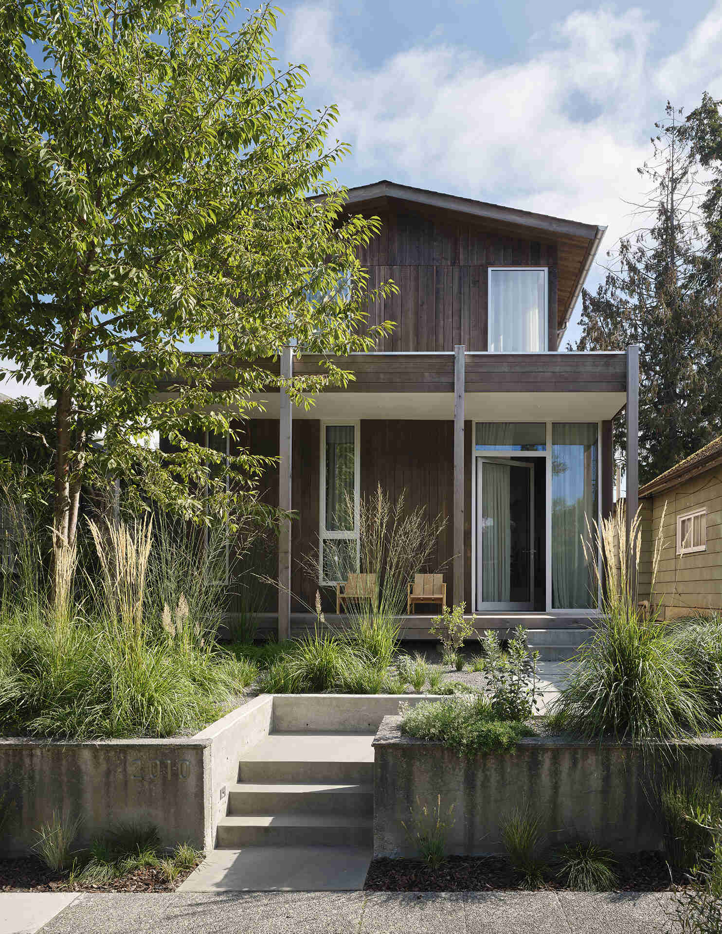 Natural cedar siding, native landscaping, and a simple gabled roof give this Seattle home a timeless Pacific Northwest character.