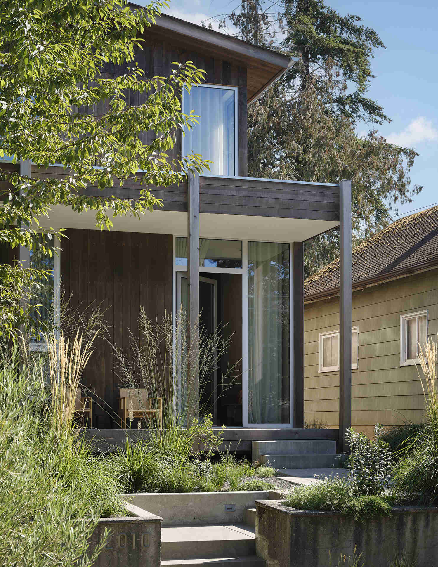 Natural cedar siding, native landscaping, and a simple gabled roof give this Seattle home a timeless Pacific Northwest character.
