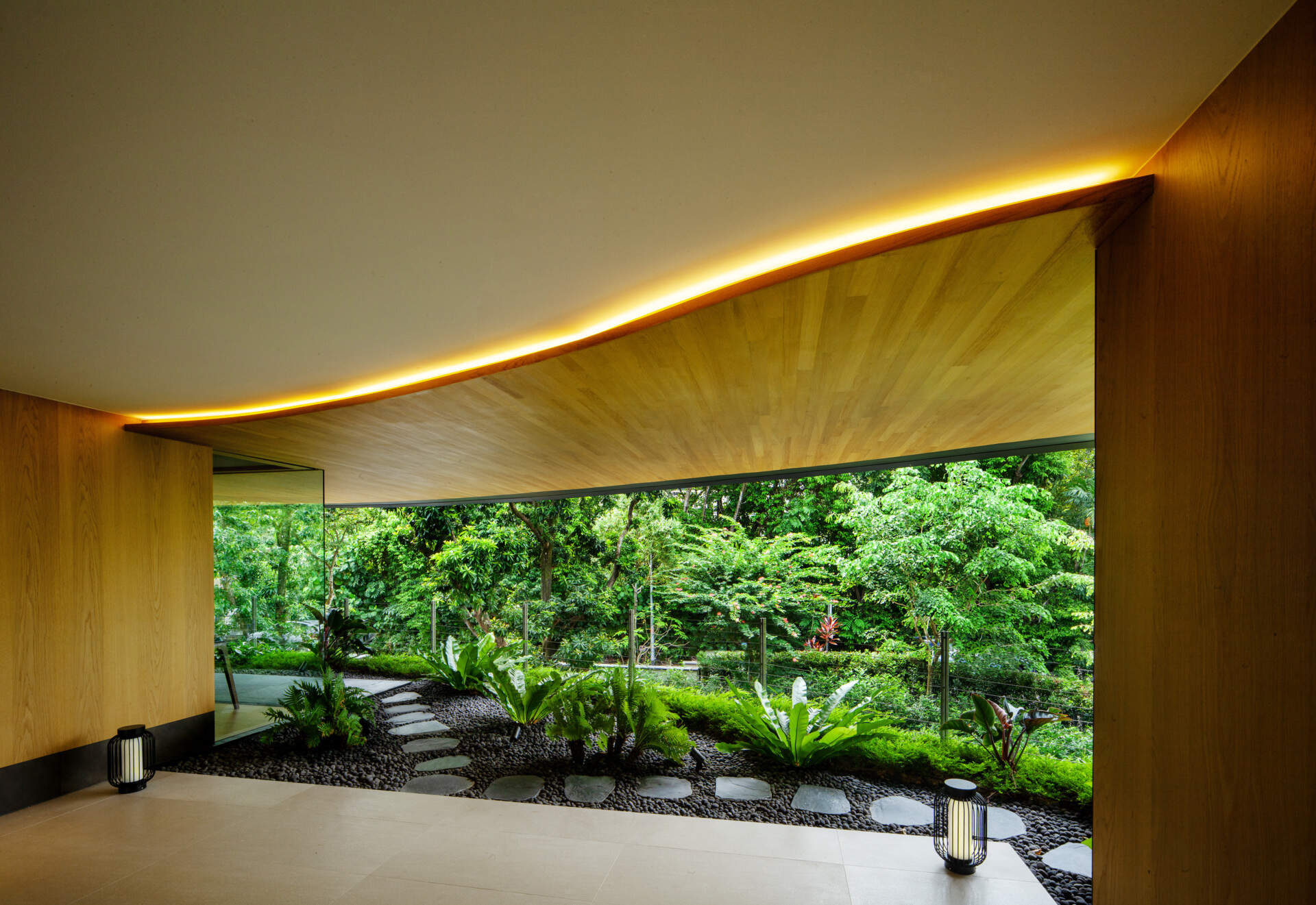 A multi-generational home filled with terraced gardens, rooftop lawns, reflecting ponds, and breathtaking city views. Warm timber interiors, tropical landscaping, open-air walkways, and a lagoon-like pool create a beautiful blend of architecture and nature.