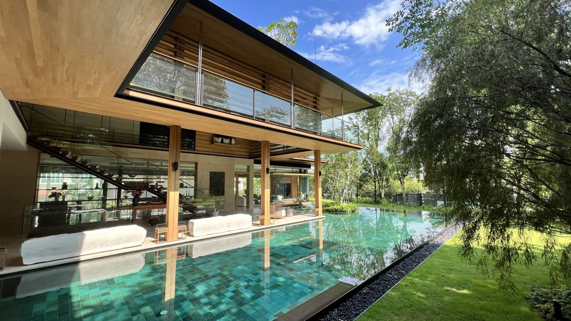 Sky Pavilion House by Guz Architects transforms an unusual Singapore site into a lush garden-focused home with a rooftop pavilion, glass staircase, swimming pool, and smart passive cooling features. Discover how greenery, natural breezes, and tropical design come together in this stunning residence.