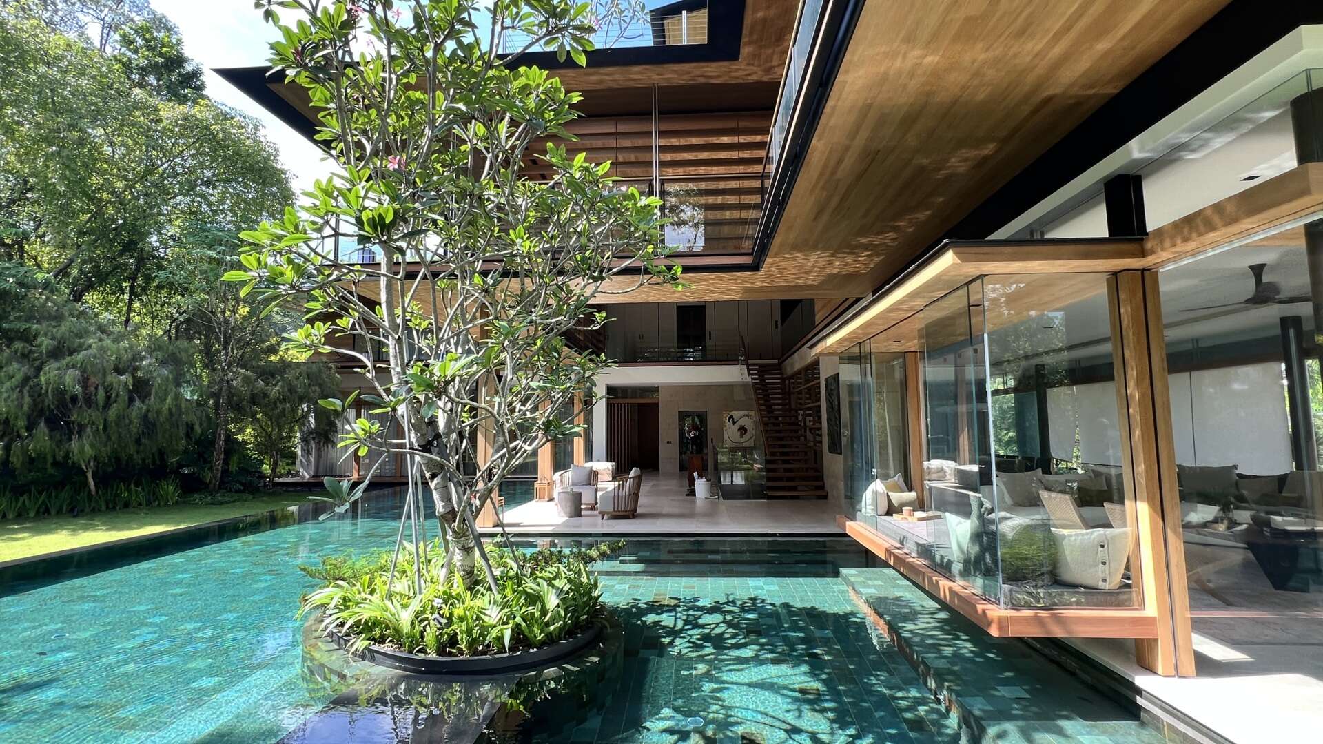 Sky Pavilion House by Guz Architects transforms an unusual Singapore site into a lush garden-focused home with a rooftop pavilion, glass staircase, swimming pool, and smart passive cooling features. Discover how greenery, natural breezes, and tropical design come together in this stunning residence.