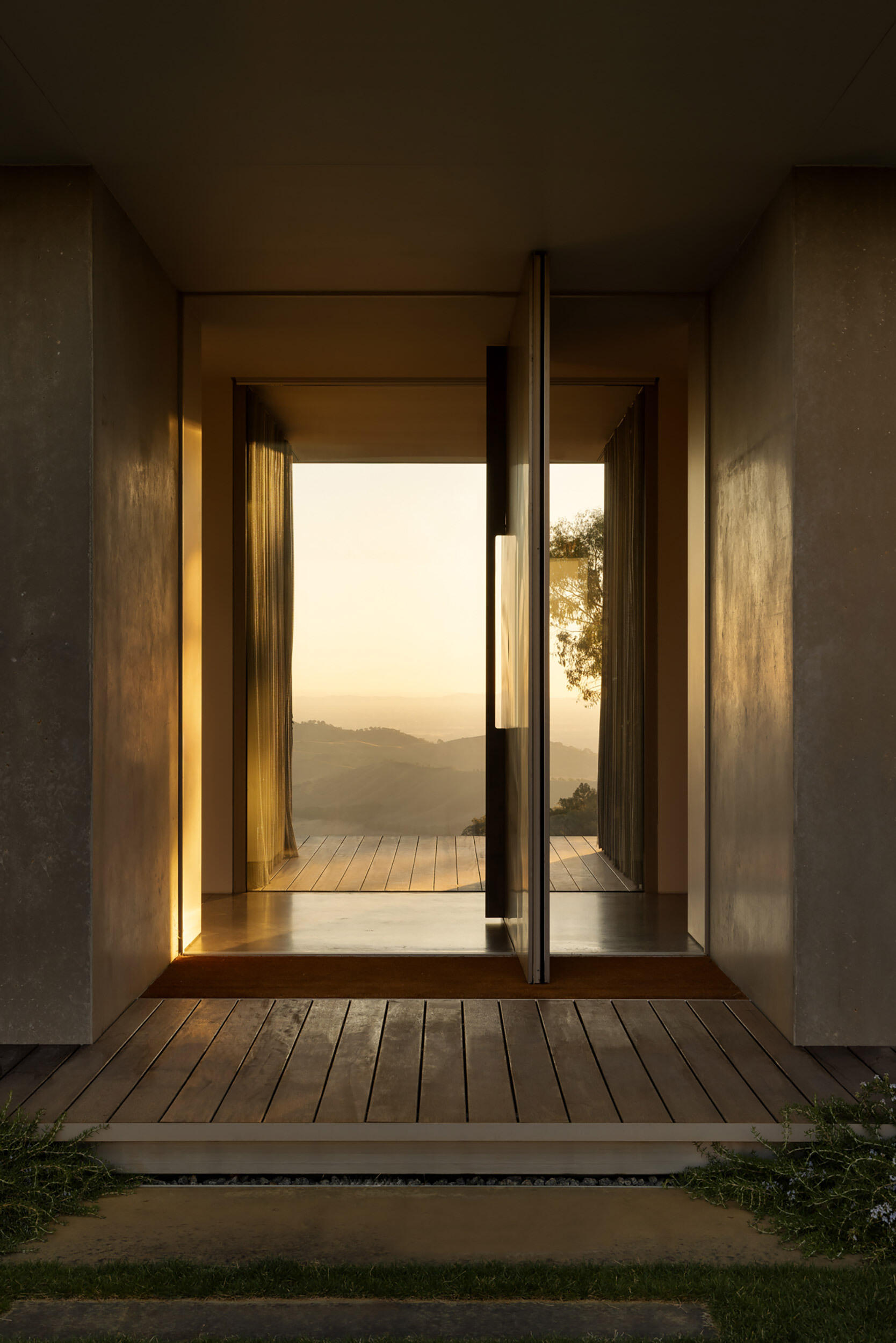 The transition from sheltered courtyard to expansive valley views creates a memorable entry sequence filled with contrast and discovery.