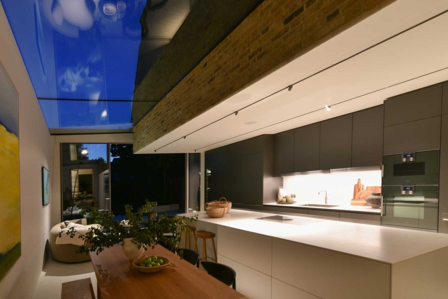 A dramatic linear skylight floods this open-plan extension with natural light while framing views of the original Victorian home and even the stars at night.