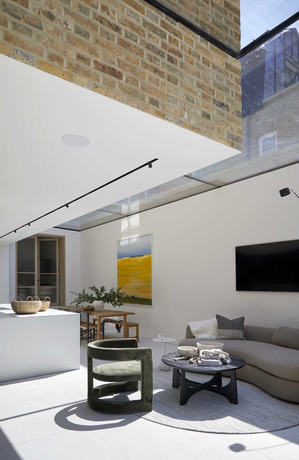 A dramatic linear skylight floods this open-plan extension with natural light while framing views of the original Victorian home and even the stars at night.