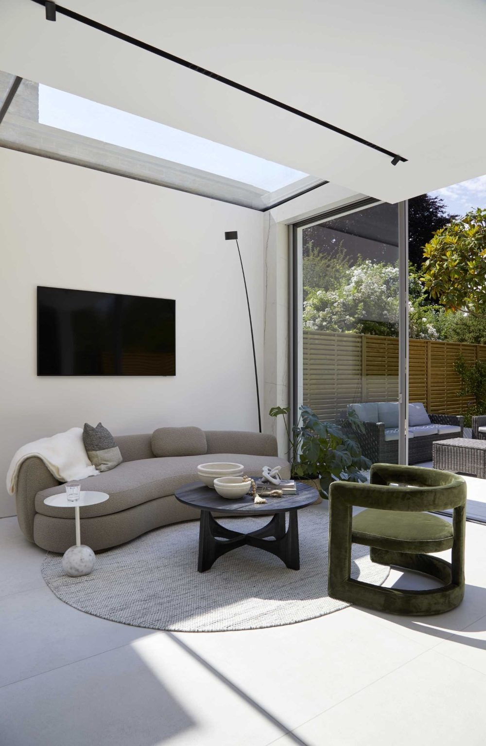 A dramatic linear skylight floods this open-plan extension with natural light while framing views of the original Victorian home and even the stars at night.