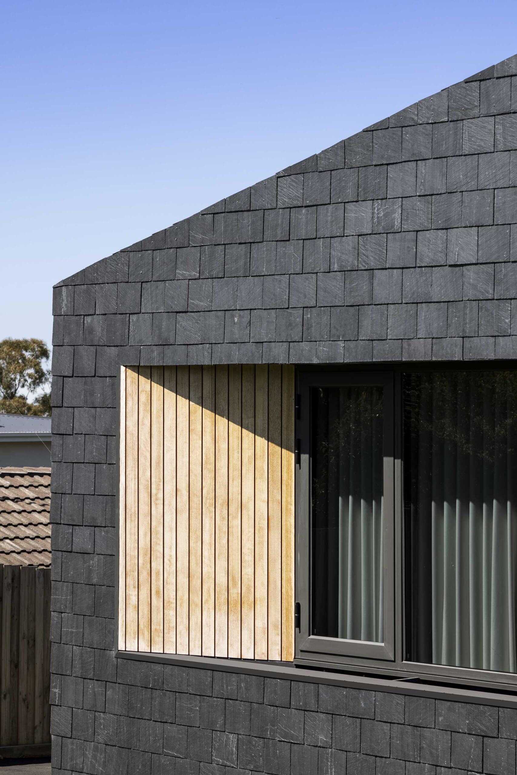 Black Spanish slate shingles and warm Iron Ash timber combine to create a striking Melbourne home with a modern yet inviting exterior.