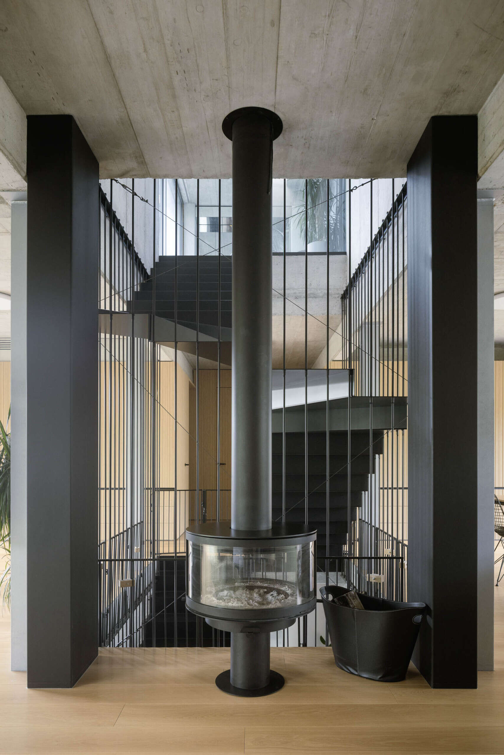 Set between the Carpathian foothills and the Danube River, this modern house features elevated living spaces, flexible interiors, panoramic views, a rooftop terrace, and a reflective raw aluminum facade that changes with the light throughout the day.