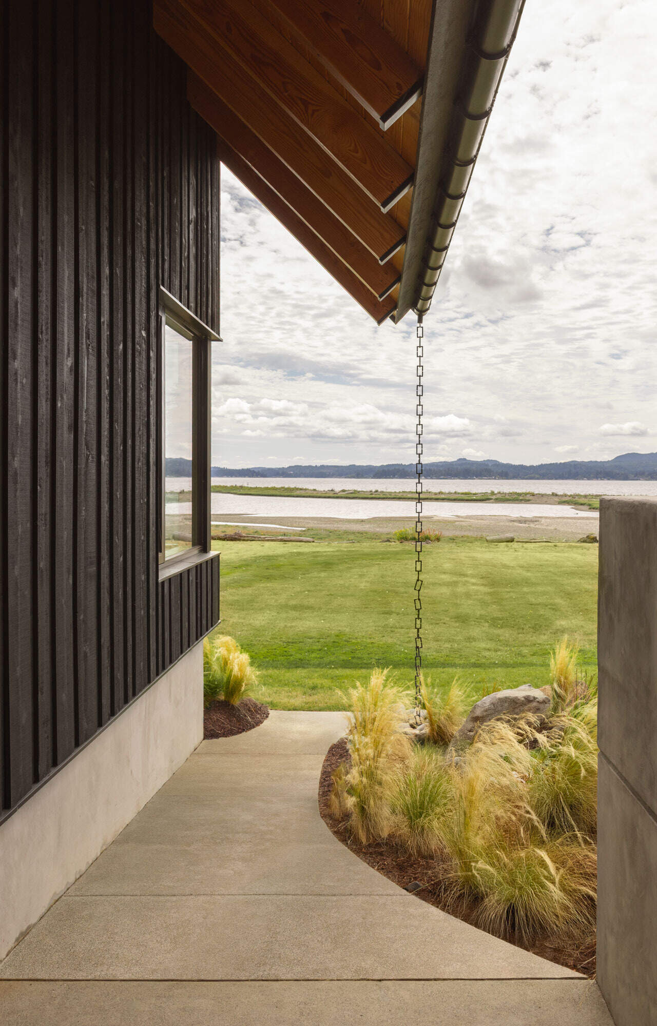 Thoughtful landscaping helps create privacy while opening beautiful sightlines toward the waters of Dyes Inlet on Washington's Kitsap Peninsula.
