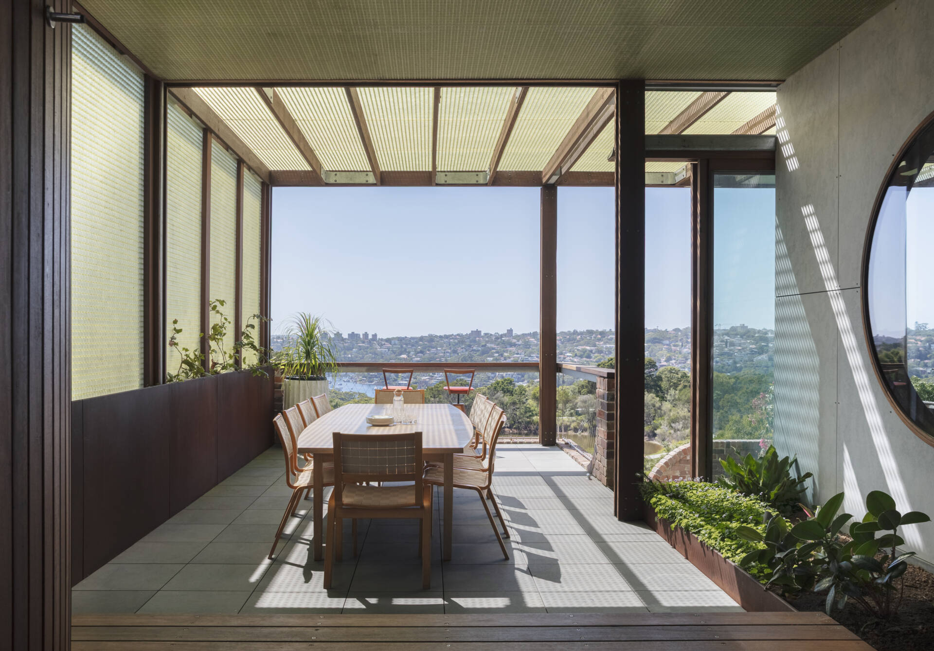 Covered outdoor dining areas connect directly to the kitchen and living spaces, creating effortless indoor-outdoor entertaining.