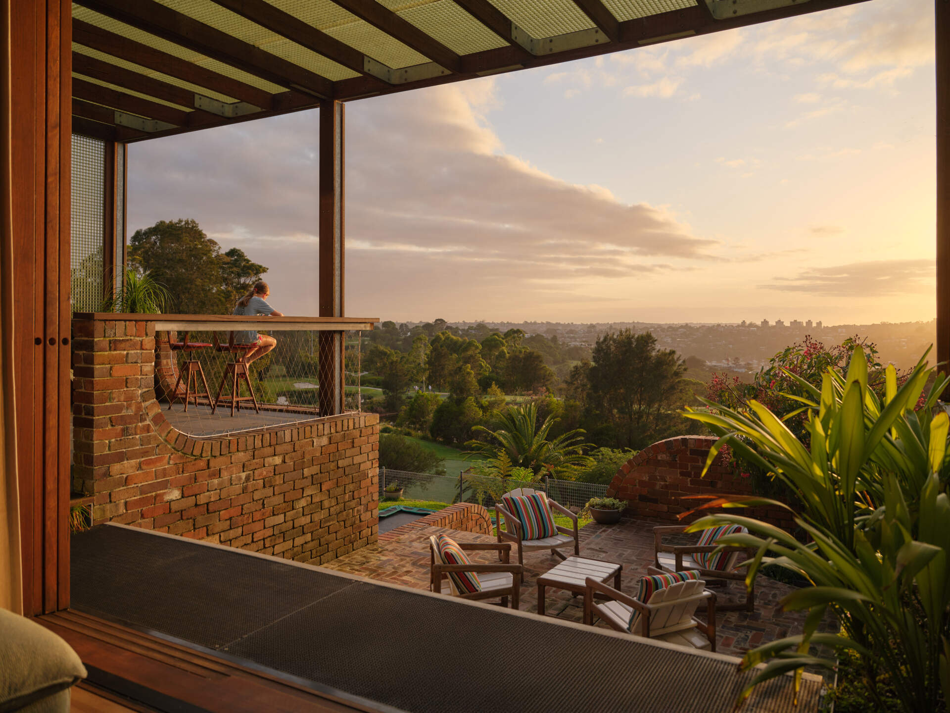 Covered outdoor dining areas connect directly to the kitchen and living spaces, creating effortless indoor-outdoor entertaining.