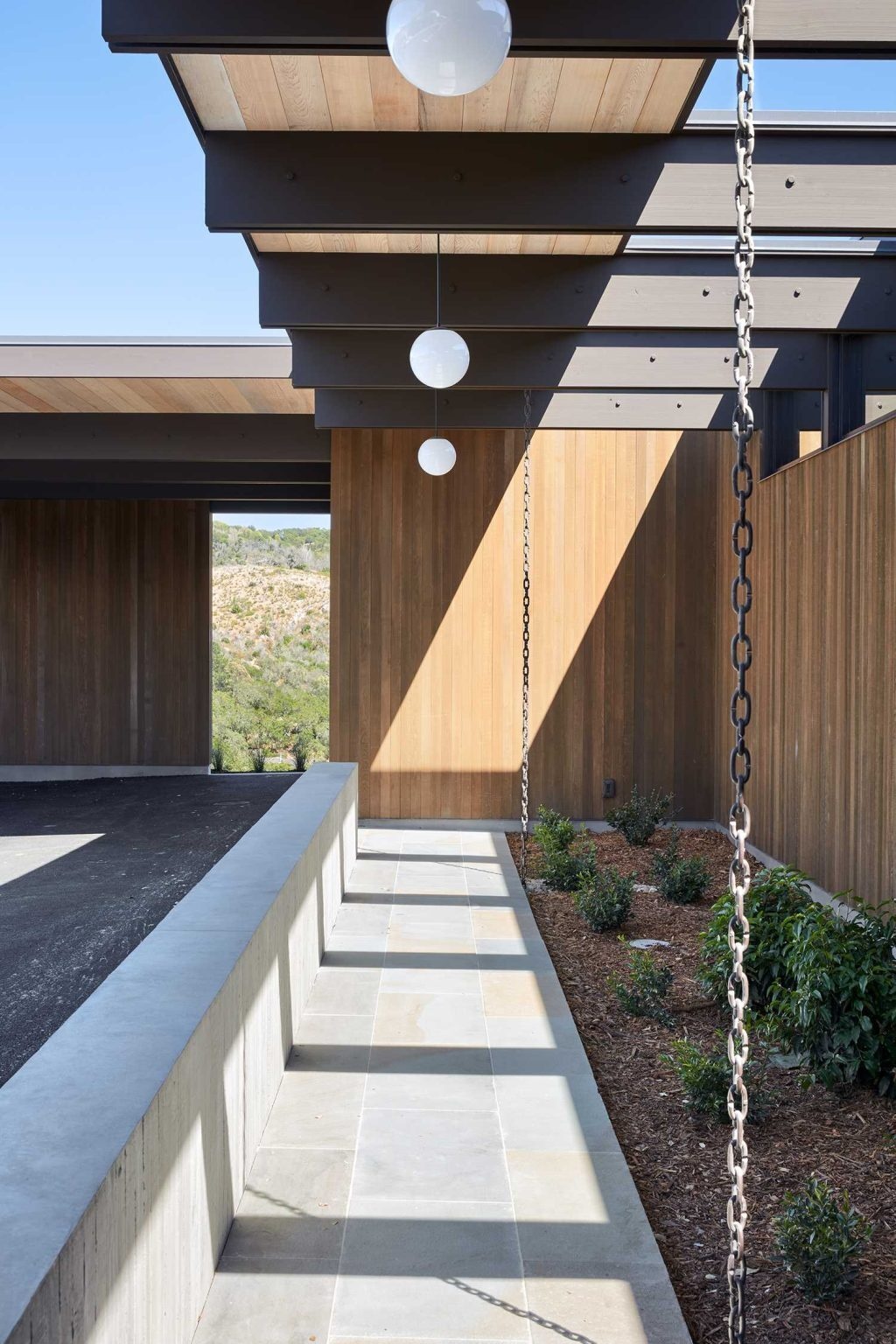 Rain chains add both function and visual appeal, directing water into the gardens while enhancing the home's exterior.
