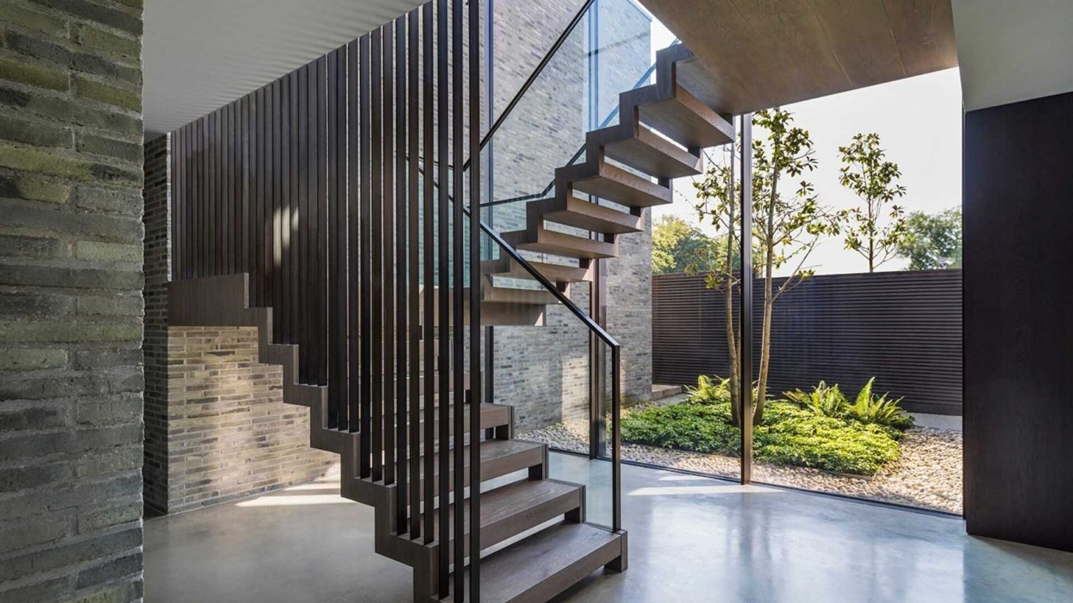 Dark stained oak appears throughout this home, creating a warm contrast to concrete, steel, and stone finishes.