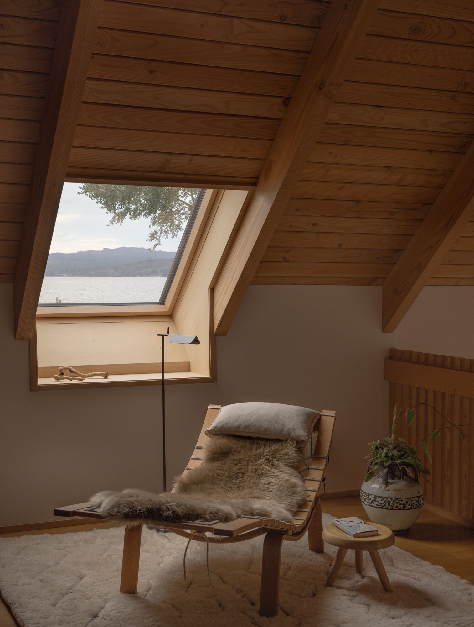 An elevated loft provides flexible office and storage space while overlooking the home's dramatic interior volumes.