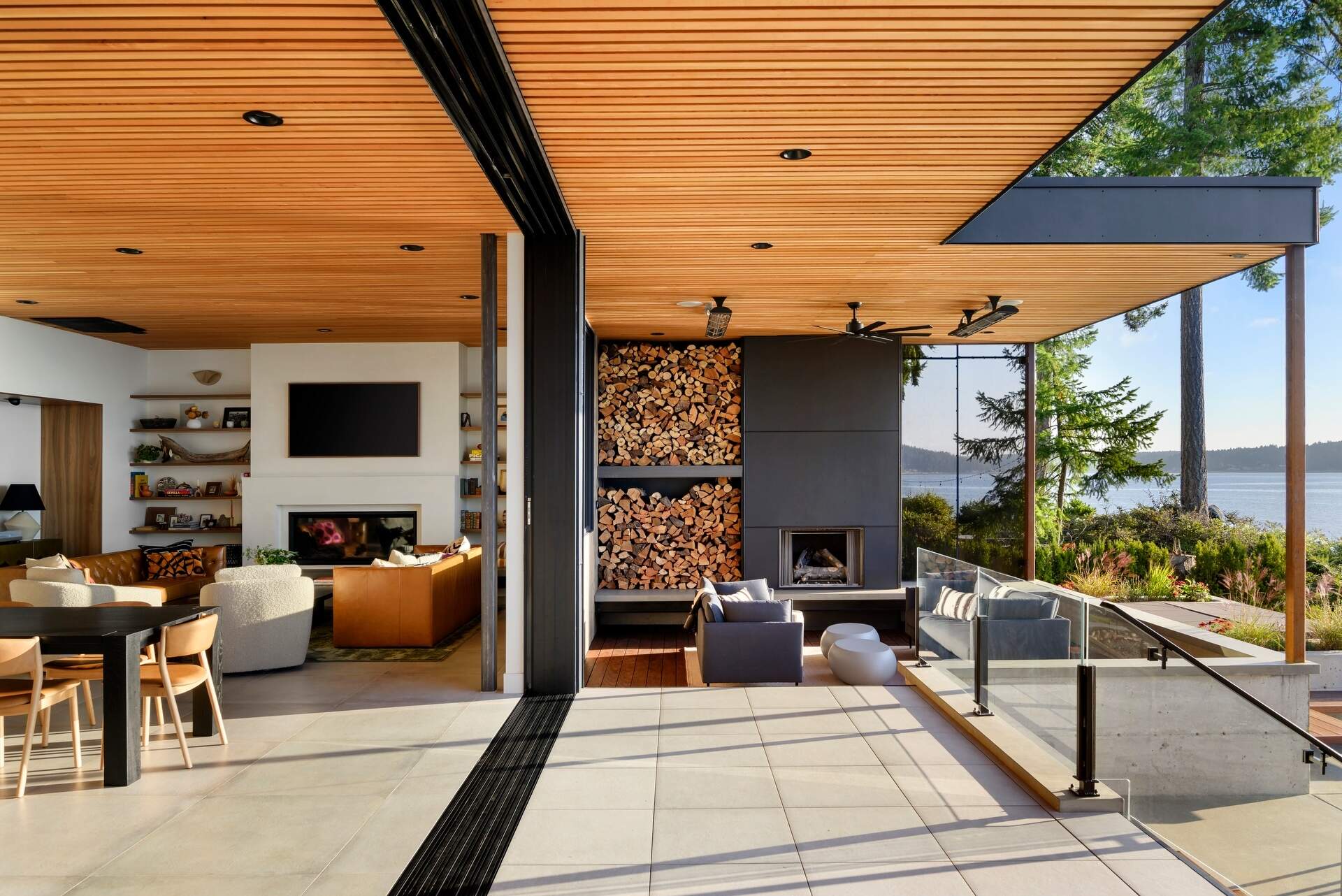 Outdoor spaces were an essential part of this house design, with expansive terraces, decks, a covered fireplace, and a hot tub extending everyday living outside. These areas provide the perfect place to enjoy sunrise views, entertain friends, or simply relax beside the water.