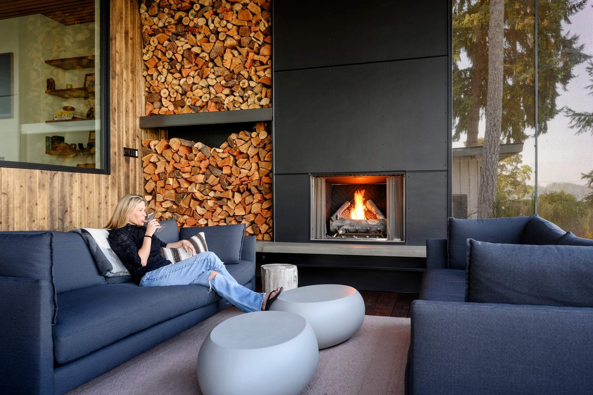 Outdoor spaces were an essential part of this house design, with expansive terraces, decks, a covered fireplace, and a hot tub extending everyday living outside. These areas provide the perfect place to enjoy sunrise views, entertain friends, or simply relax beside the water.