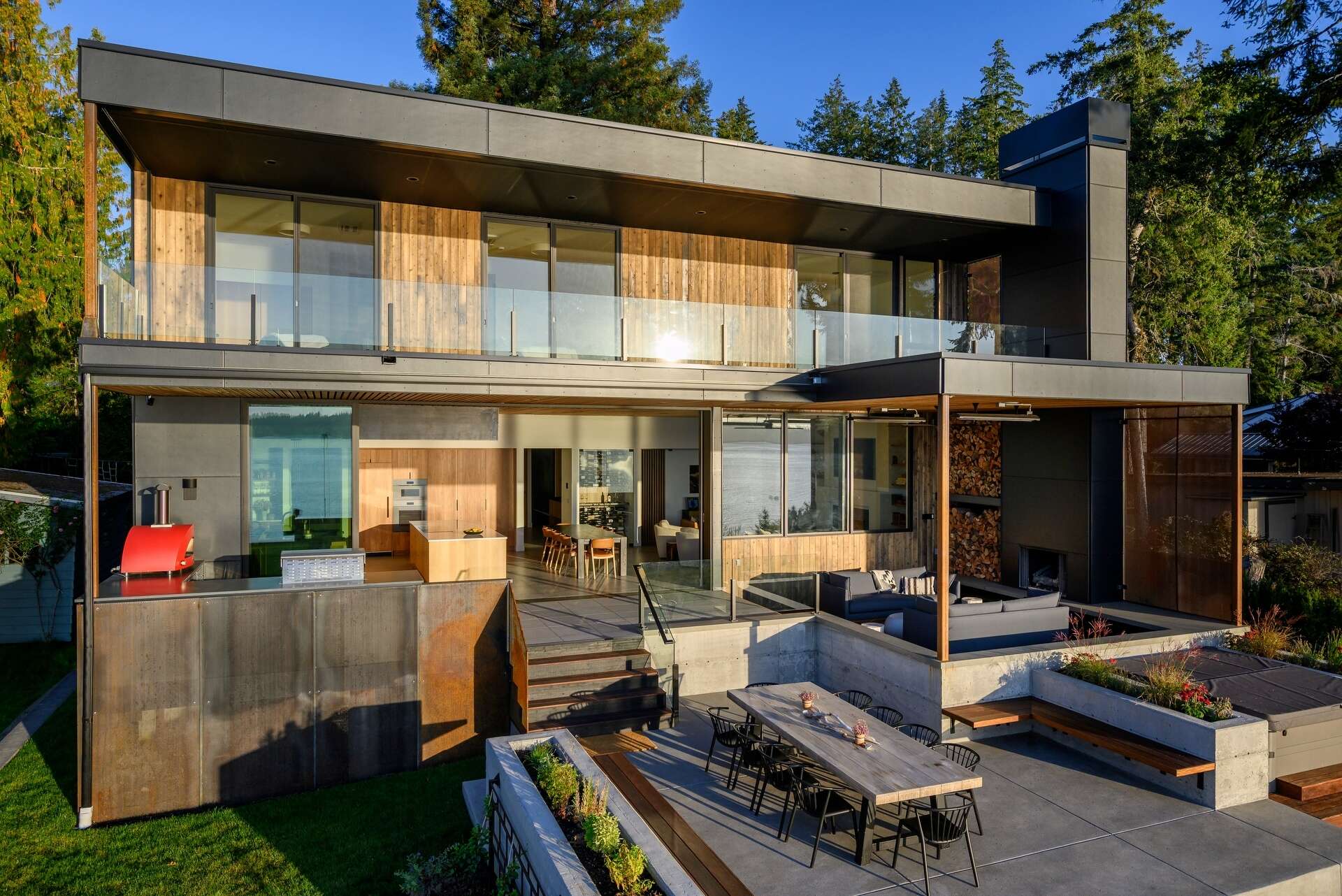 Outdoor spaces were an essential part of this house design, with expansive terraces, decks, a covered fireplace, and a hot tub extending everyday living outside. These areas provide the perfect place to enjoy sunrise views, entertain friends, or simply relax beside the water.
