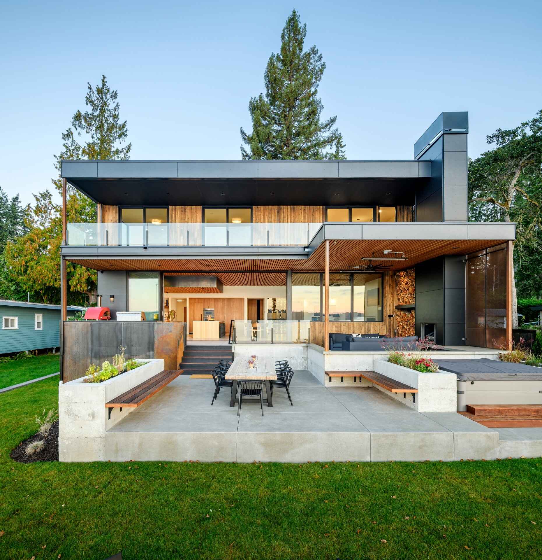 Outdoor spaces were an essential part of this house design, with expansive terraces, decks, a covered fireplace, and a hot tub extending everyday living outside. These areas provide the perfect place to enjoy sunrise views, entertain friends, or simply relax beside the water.