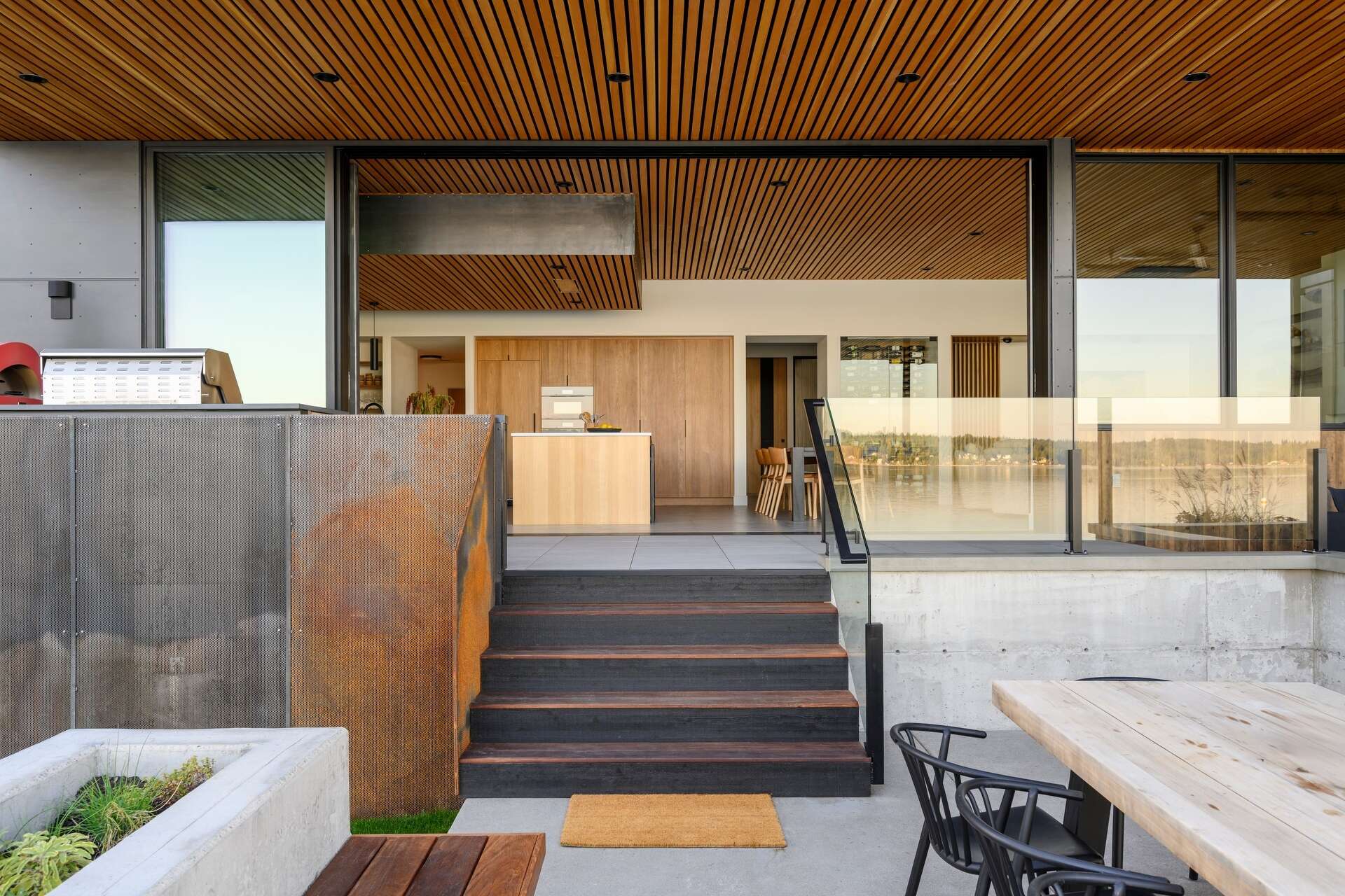 Outdoor spaces were an essential part of this house design, with expansive terraces, decks, a covered fireplace, and a hot tub extending everyday living outside. These areas provide the perfect place to enjoy sunrise views, entertain friends, or simply relax beside the water.