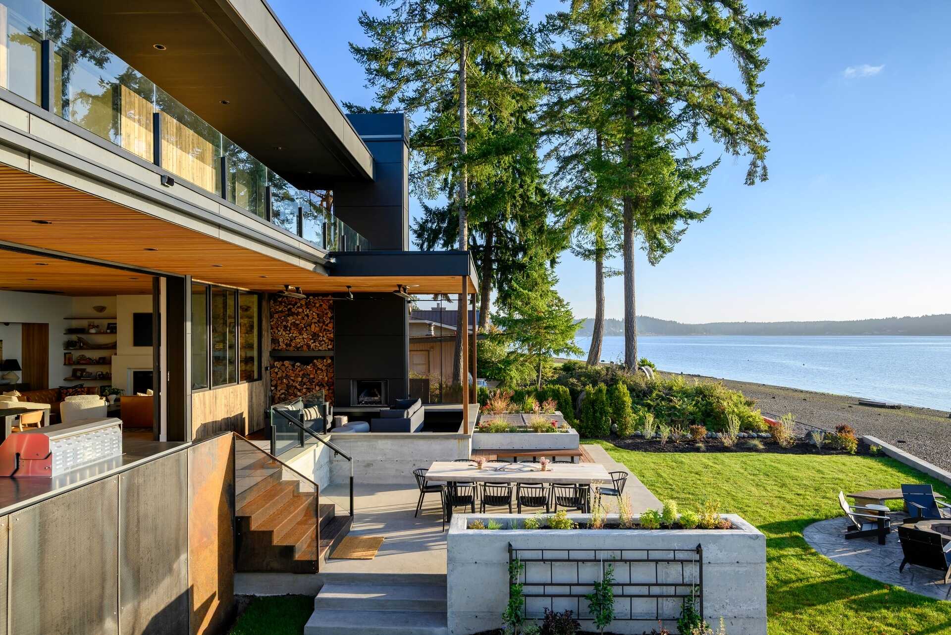 Outdoor spaces were an essential part of this house design, with expansive terraces, decks, a covered fireplace, and a hot tub extending everyday living outside. These areas provide the perfect place to enjoy sunrise views, entertain friends, or simply relax beside the water.