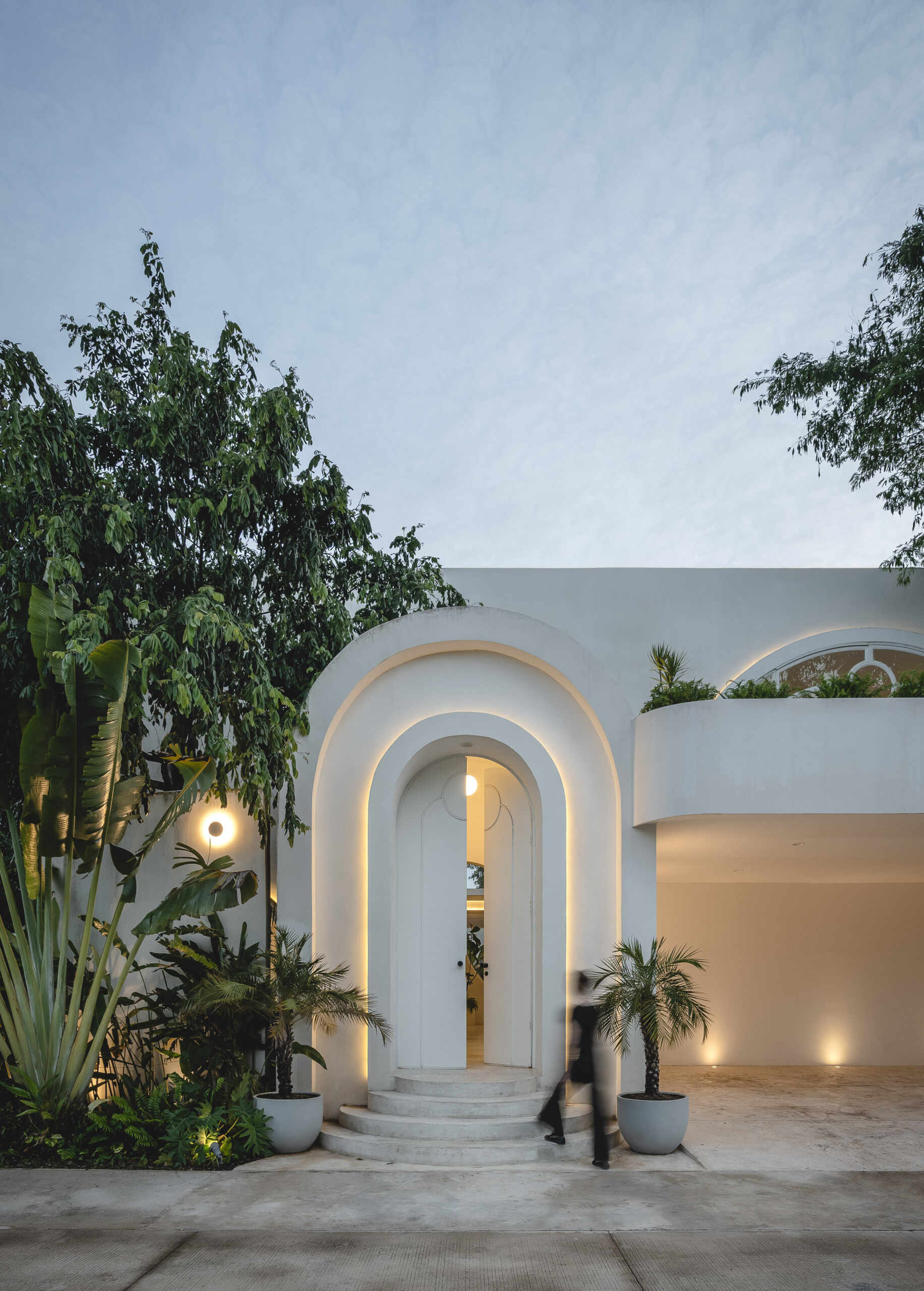 Eclipse House in Mérida, Mexico, is a striking exploration of geometry, light, and landscape. Designed by Etea and Ghostframe, the home features a dramatic double-height gallery, arch-lined walkways, circular openings that inspired its name, and lush gardens woven throughout the architecture.