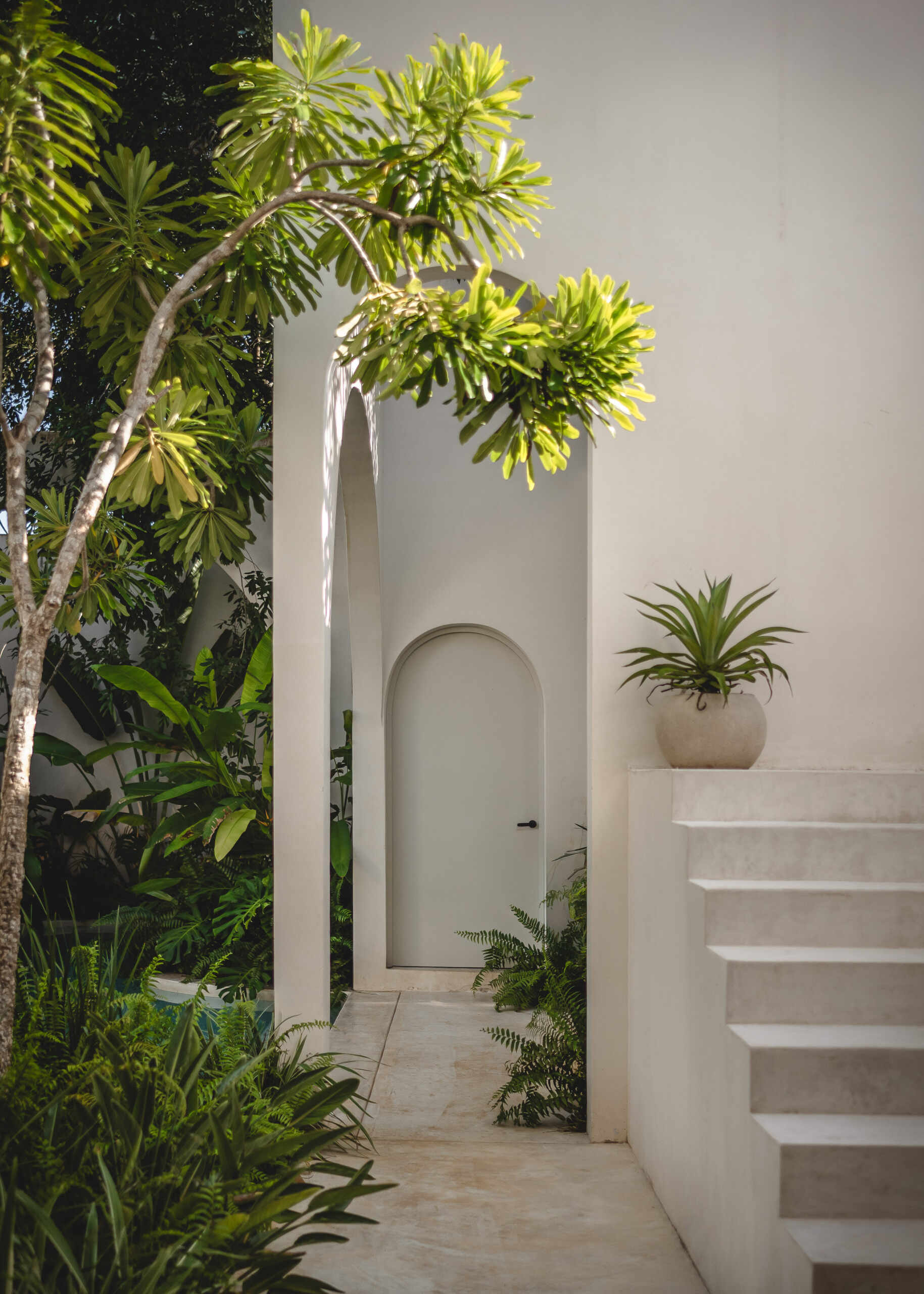 Eclipse House in Mérida, Mexico, is a striking exploration of geometry, light, and landscape. Designed by Etea and Ghostframe, the home features a dramatic double-height gallery, arch-lined walkways, circular openings that inspired its name, and lush gardens woven throughout the architecture.
