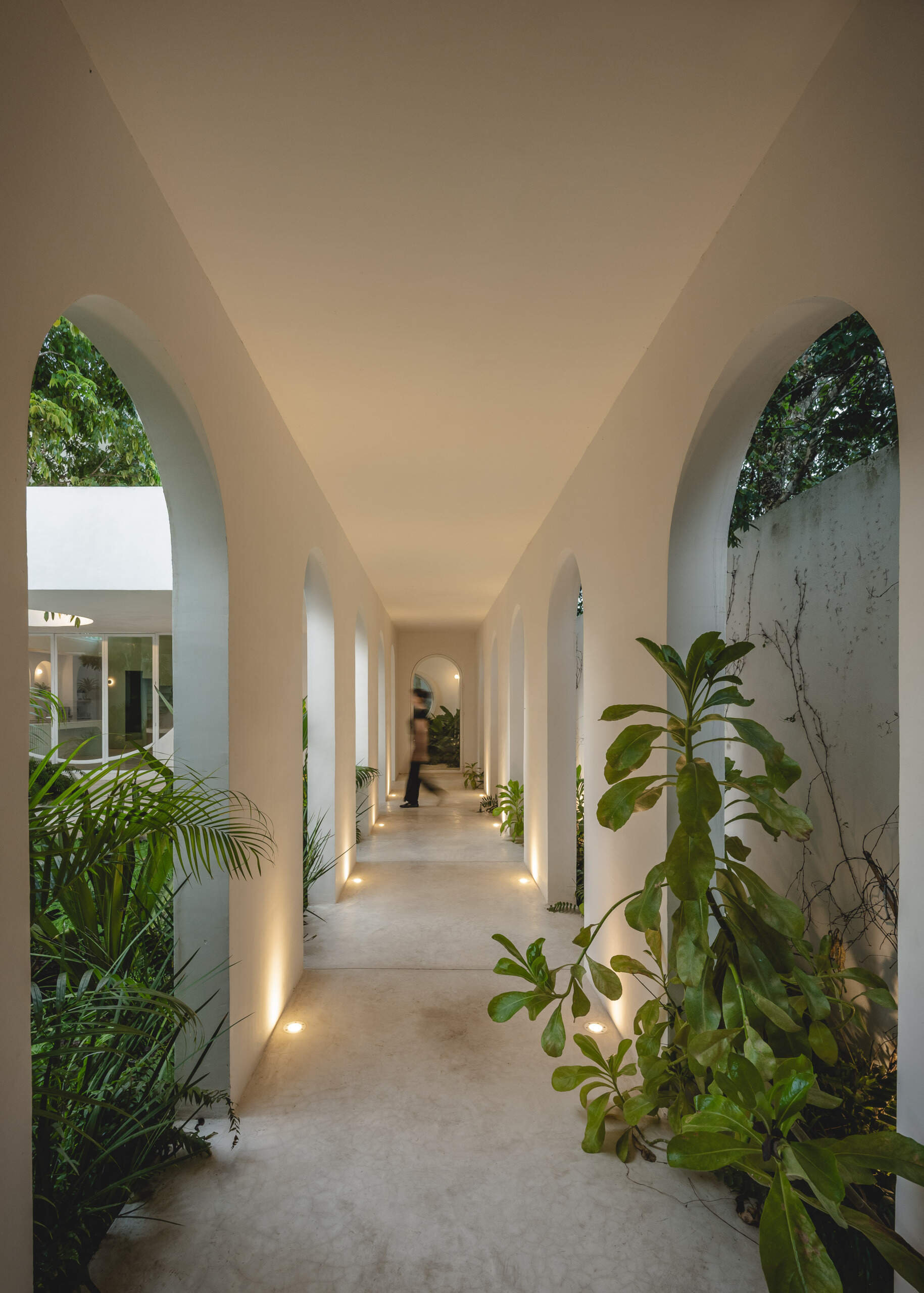 Eclipse House in Mérida, Mexico, is a striking exploration of geometry, light, and landscape. Designed by Etea and Ghostframe, the home features a dramatic double-height gallery, arch-lined walkways, circular openings that inspired its name, and lush gardens woven throughout the architecture.
