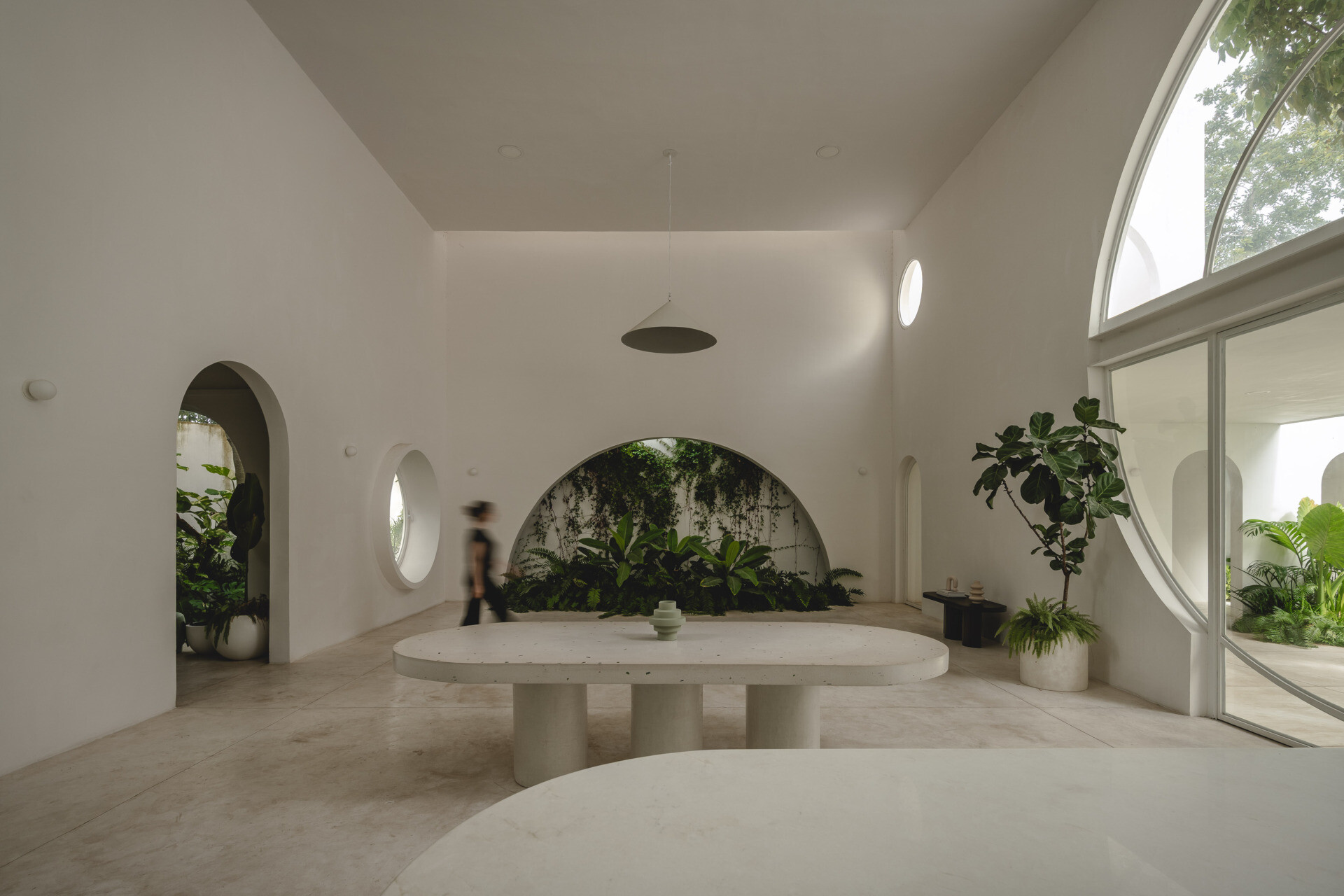 Eclipse House in Mérida, Mexico, is a striking exploration of geometry, light, and landscape. Designed by Etea and Ghostframe, the home features a dramatic double-height gallery, arch-lined walkways, circular openings that inspired its name, and lush gardens woven throughout the architecture.
