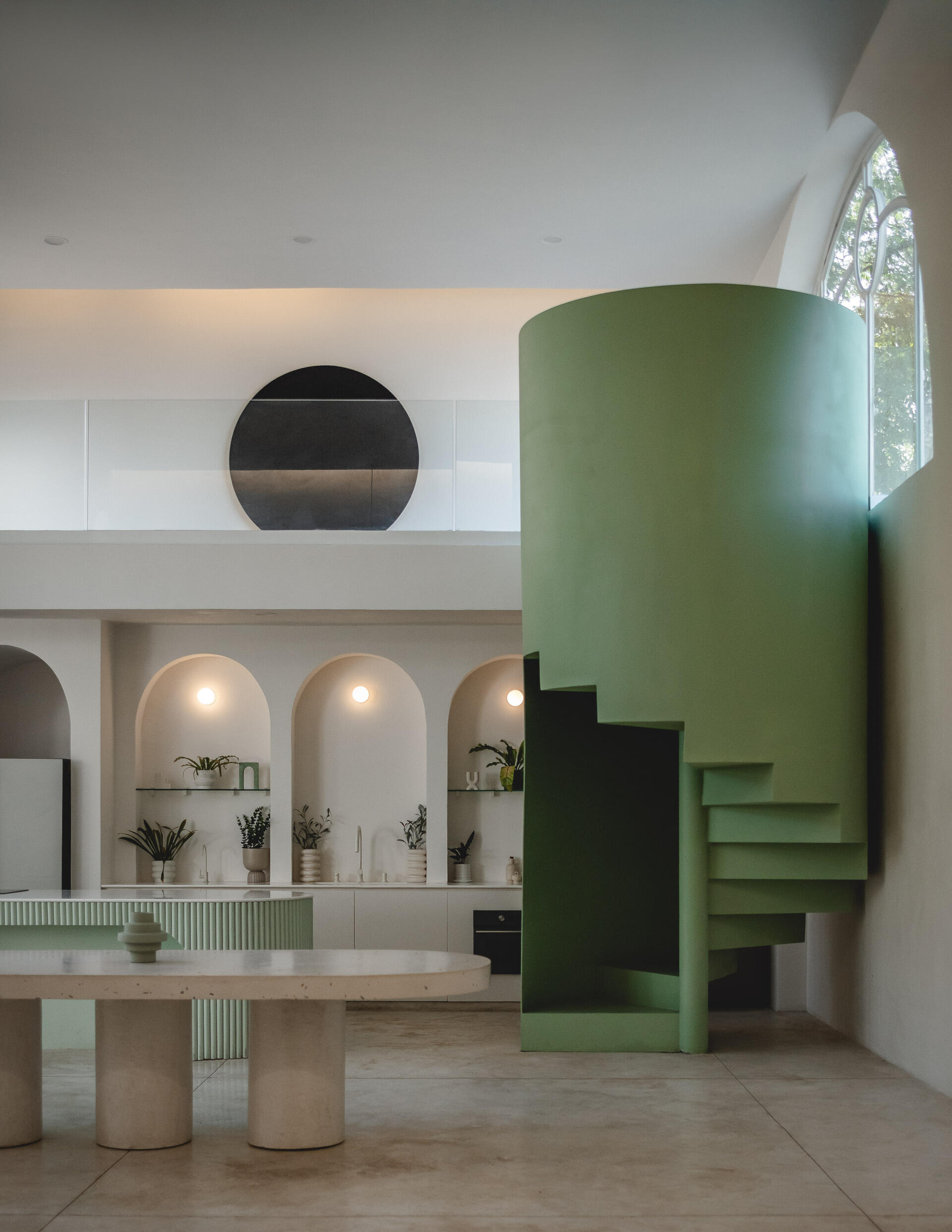 Eclipse House in Mérida, Mexico, is a striking exploration of geometry, light, and landscape. Designed by Etea and Ghostframe, the home features a dramatic double-height gallery, arch-lined walkways, circular openings that inspired its name, and lush gardens woven throughout the architecture.