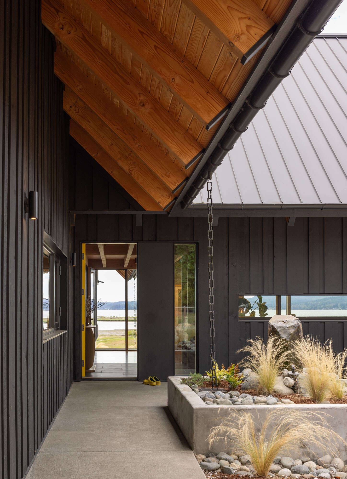 A framed waterfront view greets visitors from the entry, creating one of the most memorable moments in this Washington home.