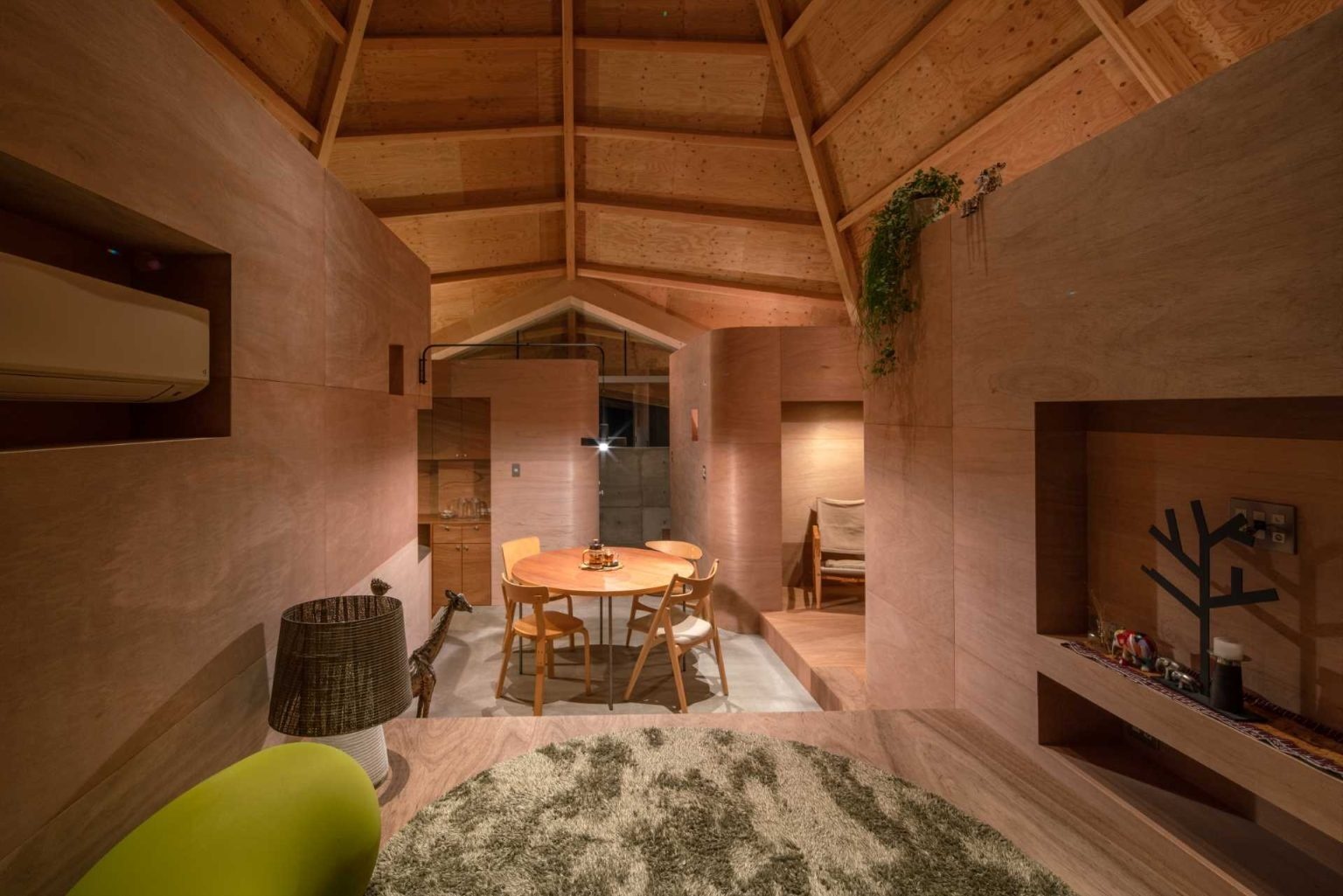 The dining room sits beneath the center of the spiderweb structure, creating a dramatic focal point enhanced by curved architectural details and striking roof geometry.