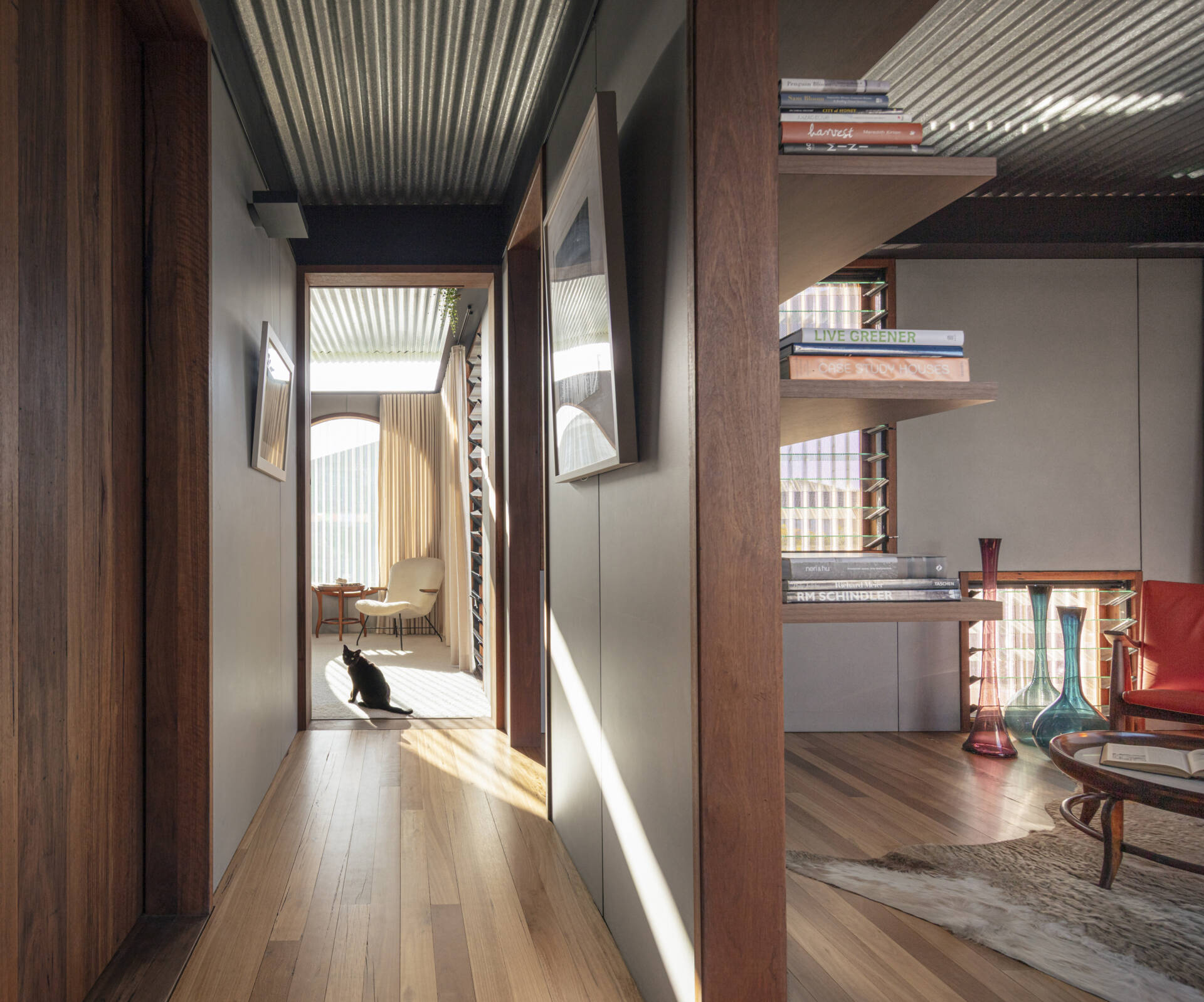 Light-filled children's bedrooms connect to gallery spaces, study areas, and playful family features throughout the upper level.