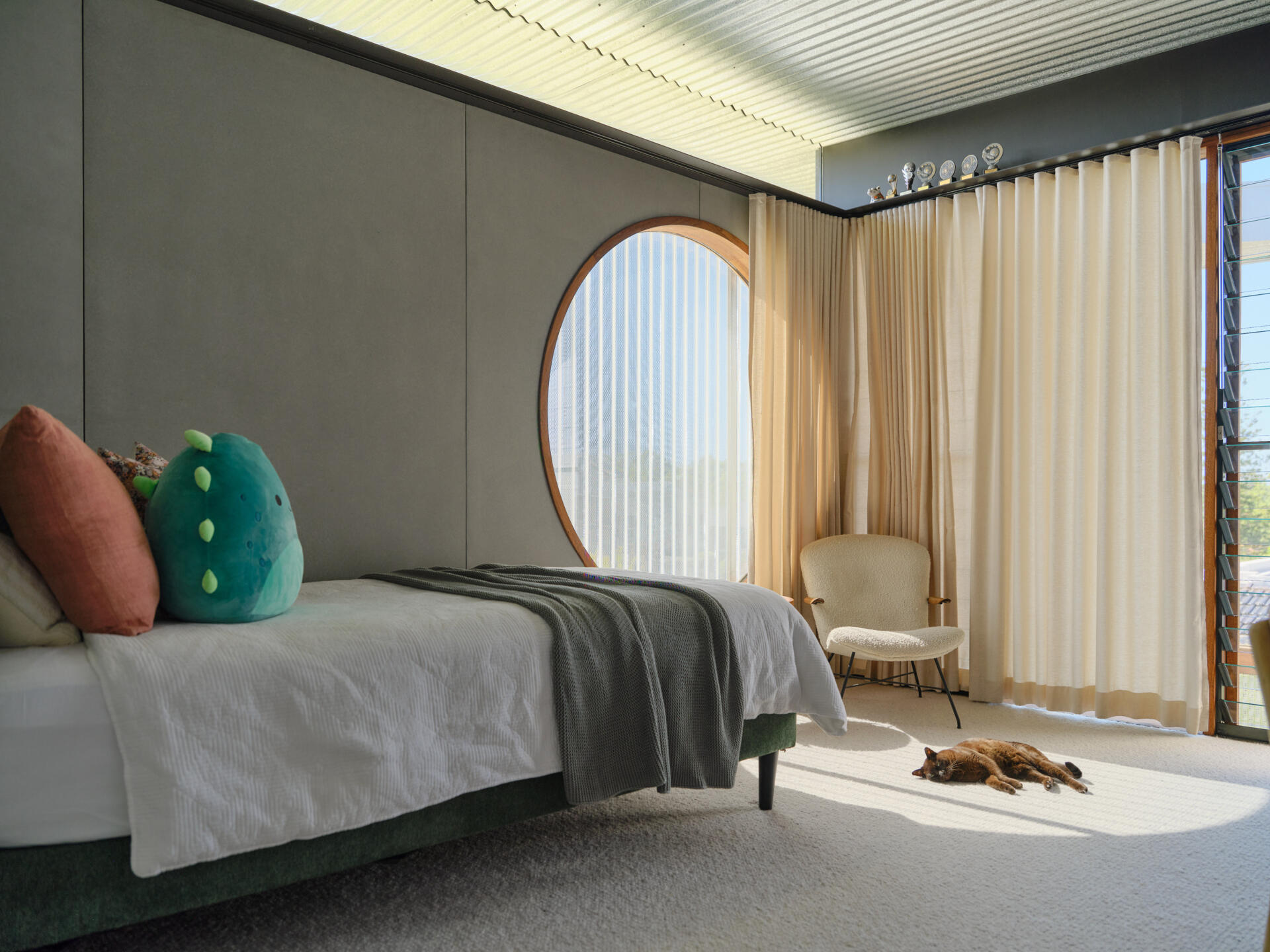 Light-filled children's bedrooms connect to gallery spaces, study areas, and playful family features throughout the upper level.