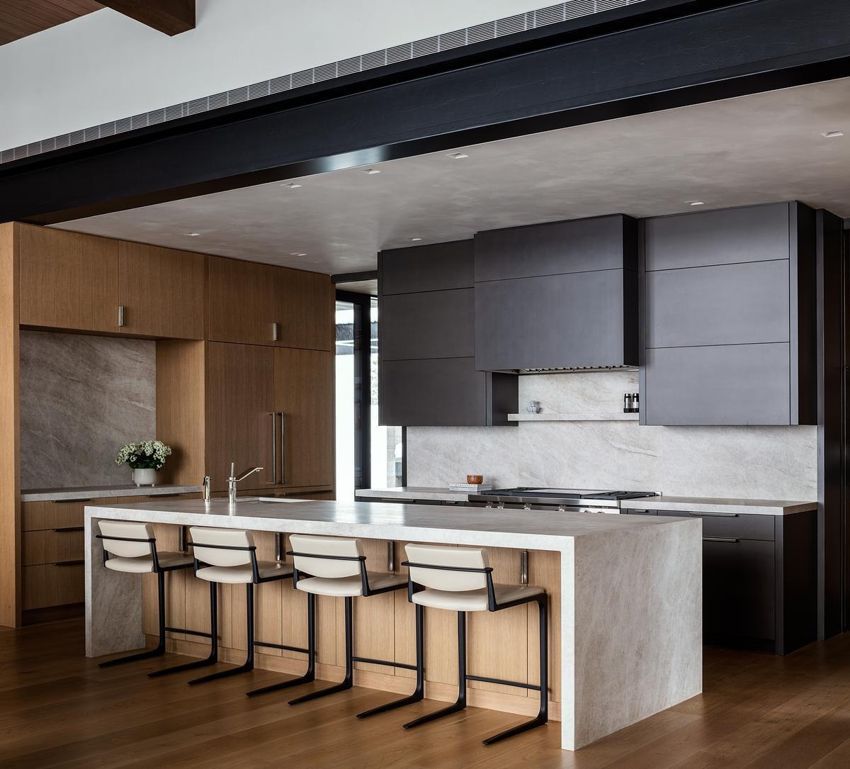 Tucked just behind the dining area, this modern kitchen balances functionality and comfort with warm materials, seamless flow, and a layout designed for everyday living.