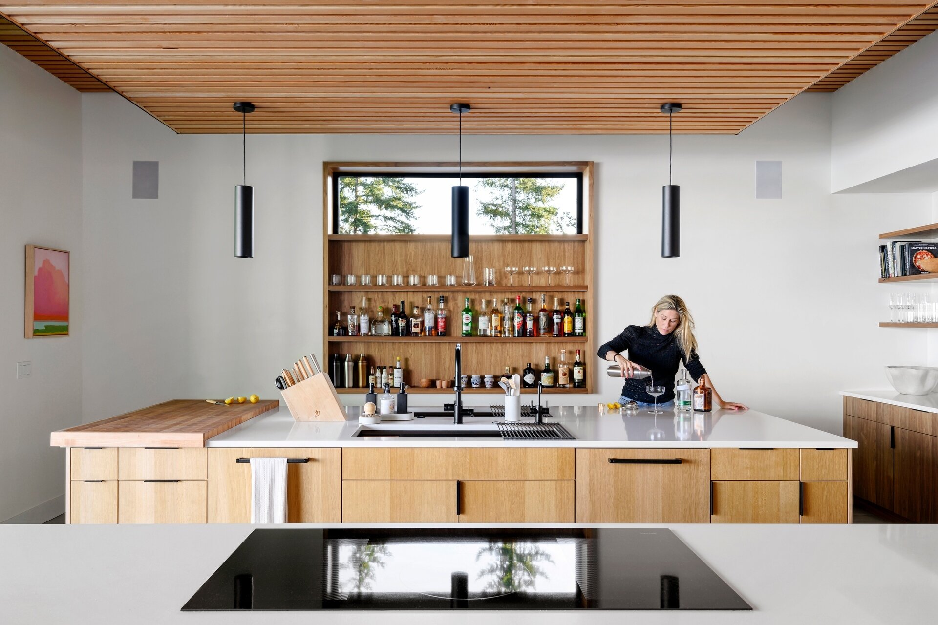 Explore the modern double-island kitchen at Lantern House, where warm timber finishes, minimalist design, and seamless indoor-outdoor living create the perfect entertaining space.