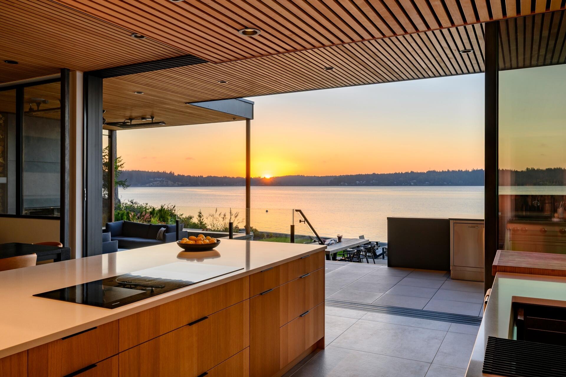 Explore the modern double-island kitchen at Lantern House, where warm timber finishes, minimalist design, and seamless indoor-outdoor living create the perfect entertaining space.