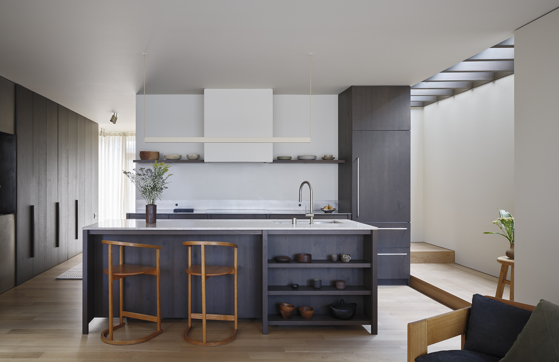 Dark wood cabinets and light countertops create a striking contrast in this modern Seattle kitchen.