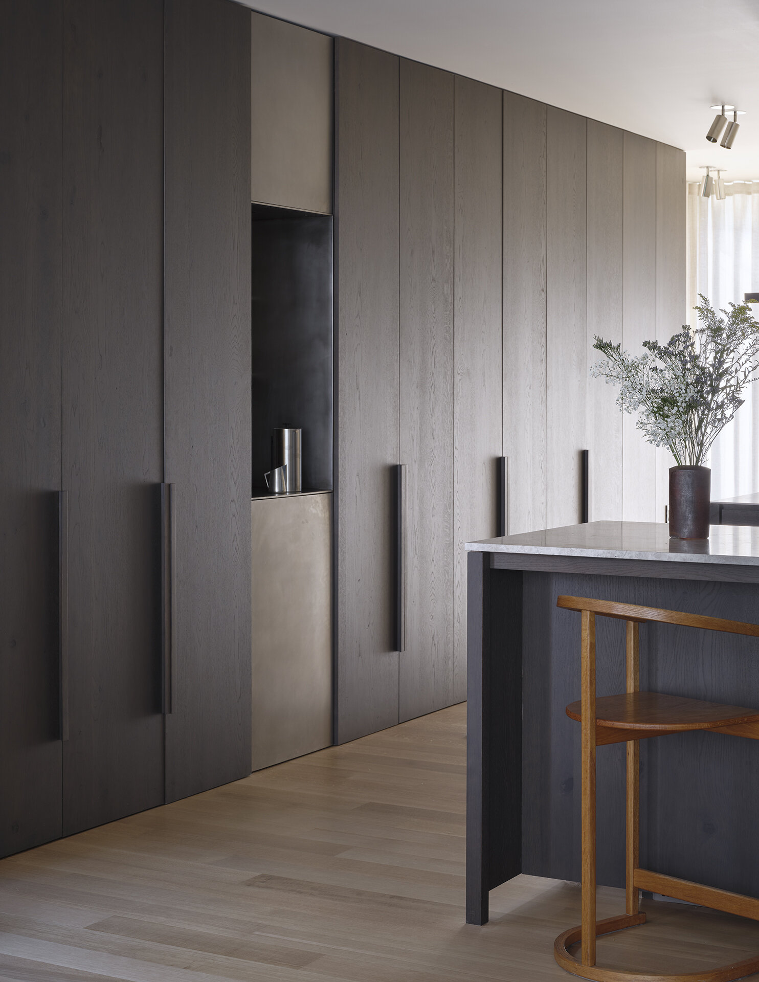 Dark wood cabinets and light countertops create a striking contrast in this modern Seattle kitchen.