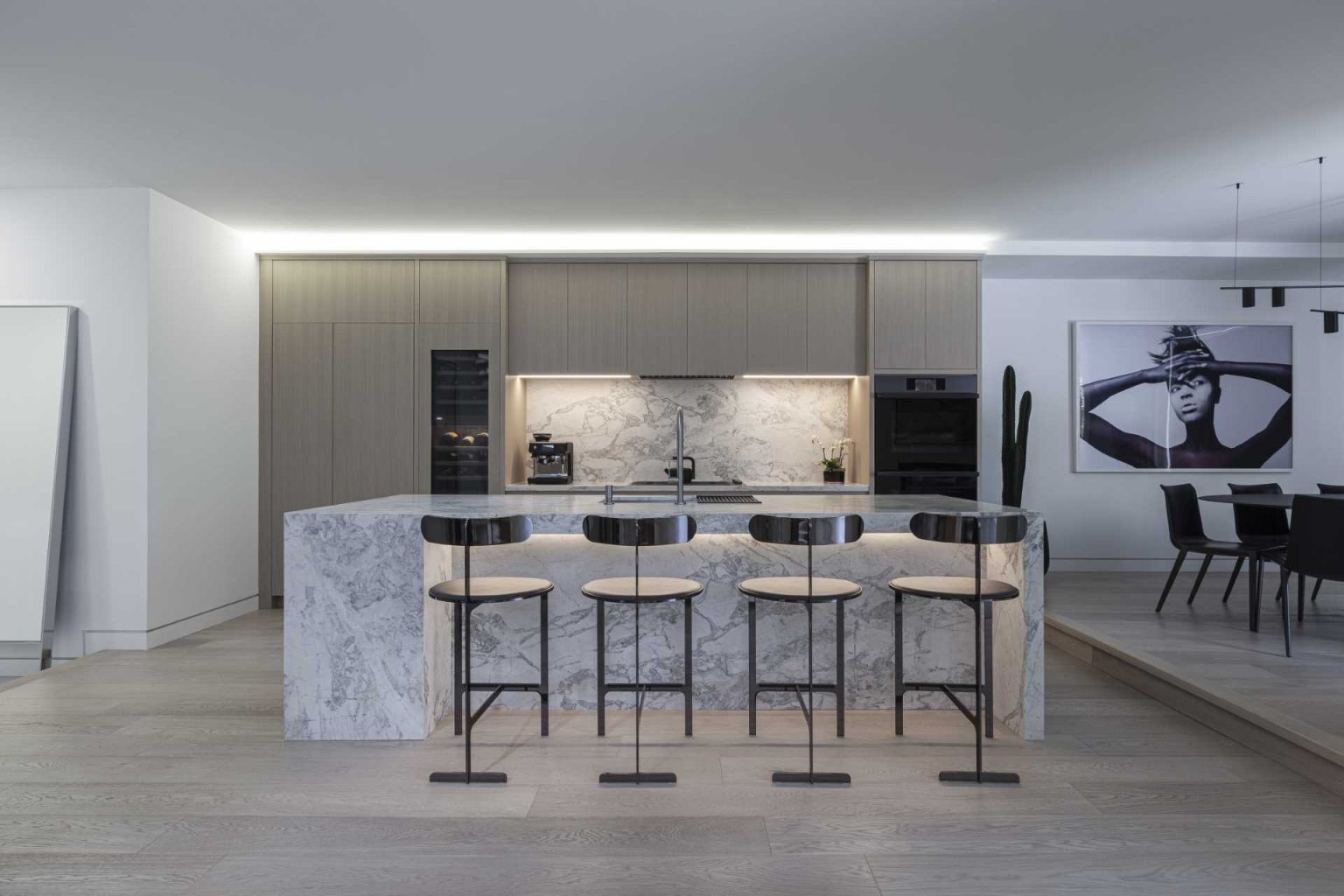 This modern kitchen pairs streamlined cabinetry with a large island that serves as both workspace and gathering spot. Clean lines and functional design keep the focus on the architecture.