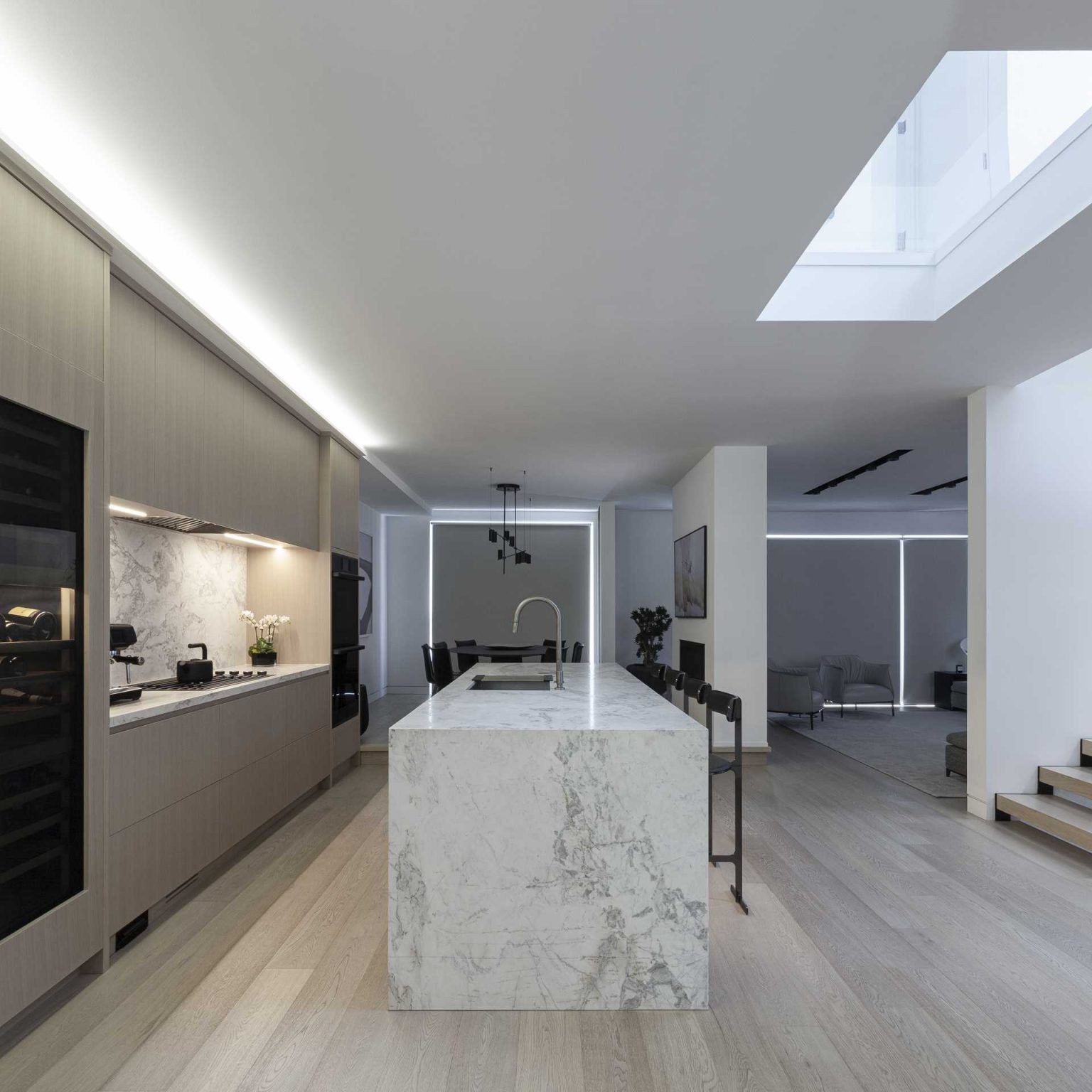 This modern kitchen pairs streamlined cabinetry with a large island that serves as both workspace and gathering spot. Clean lines and functional design keep the focus on the architecture.