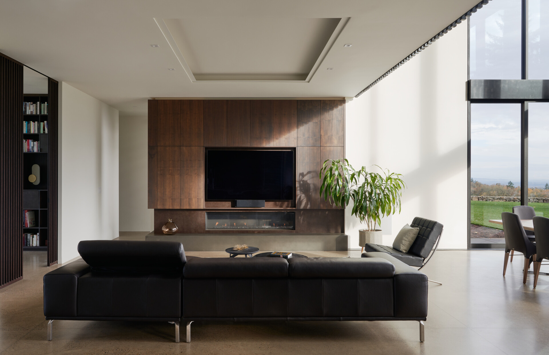 A modern open plan living room with a fireplace.