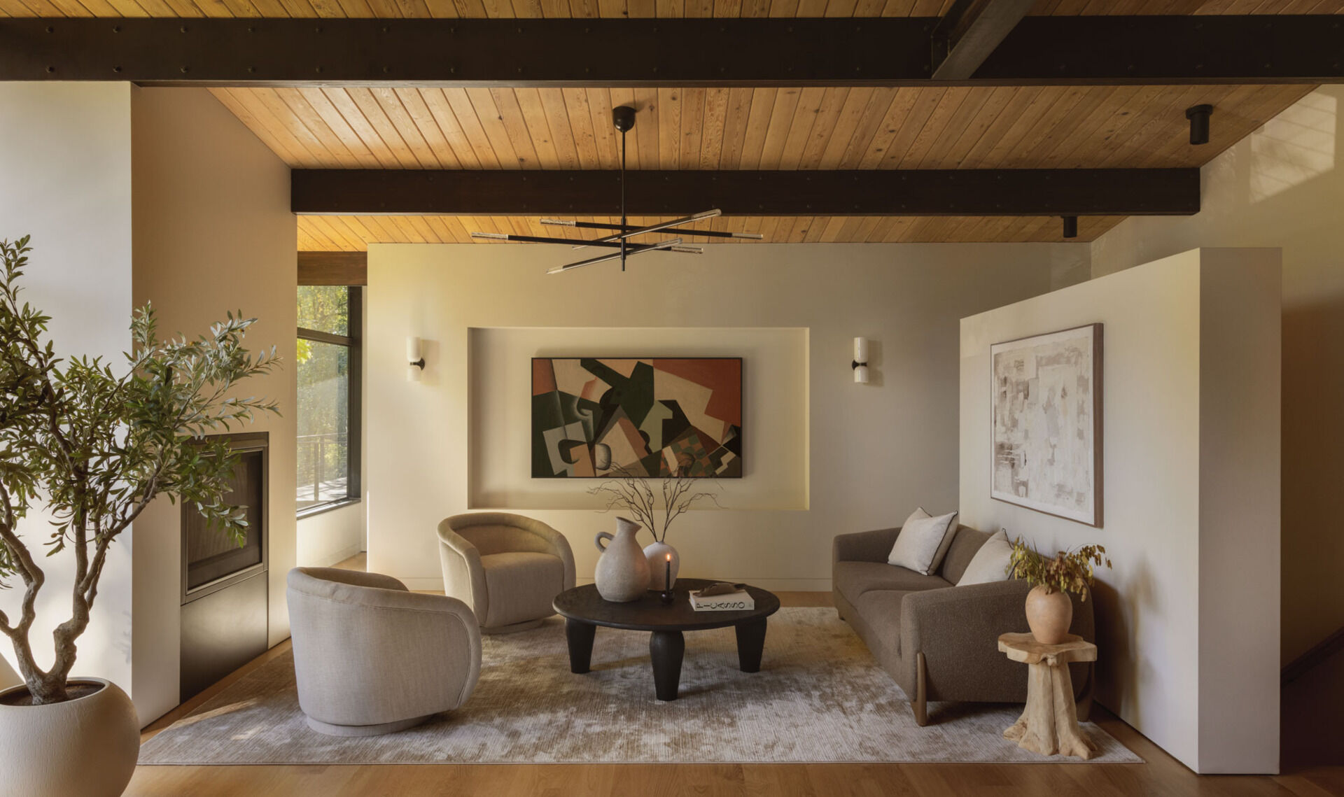 The living room at Island Crest feels bright and spacious thanks to an open layout, a sculptural partition wall, and natural light that reaches deep into the home through thoughtfully placed glazing.