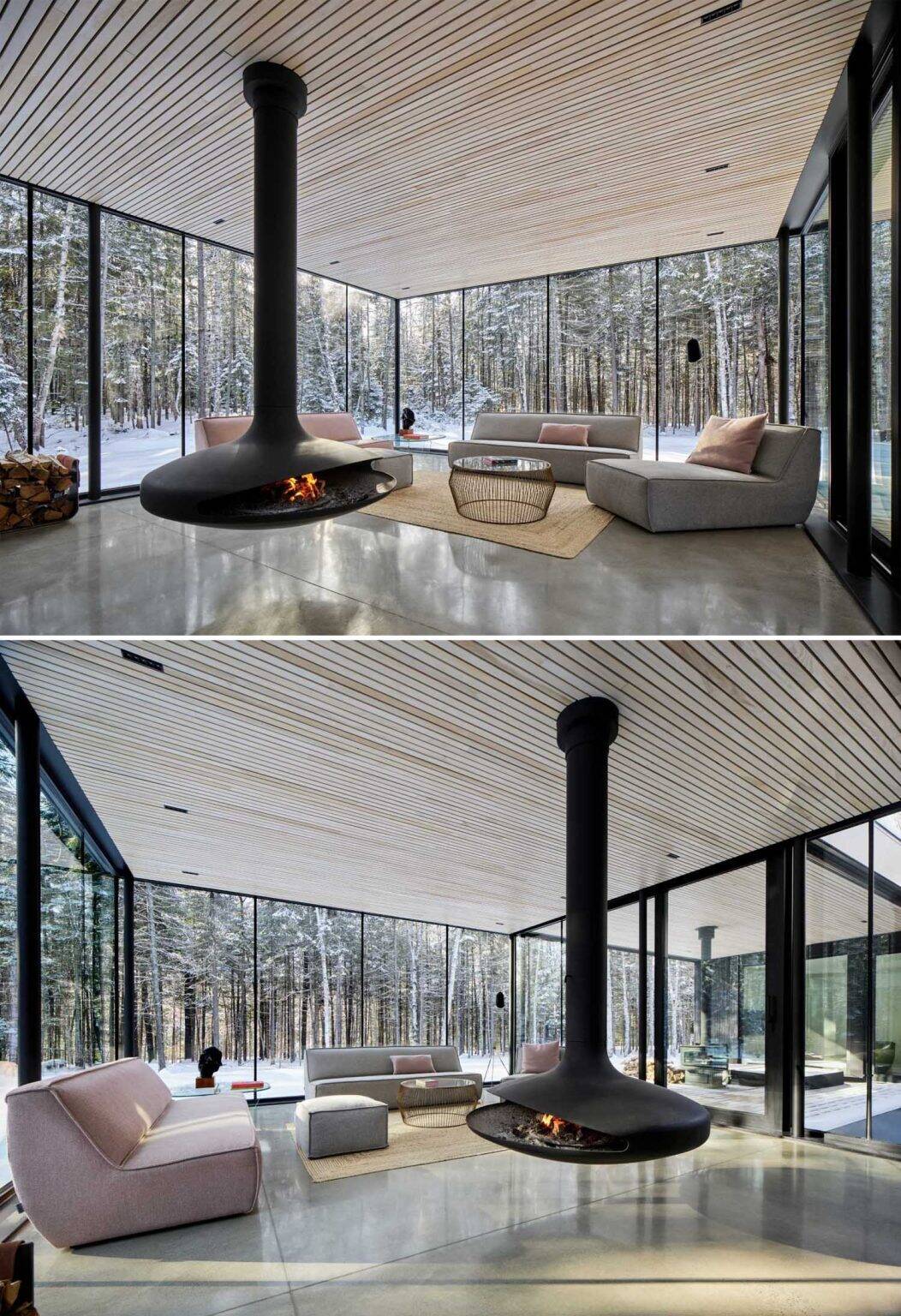 Floor-to-ceiling glass surrounds the living room, where a suspended black fireplace sits within an open space facing the forest.