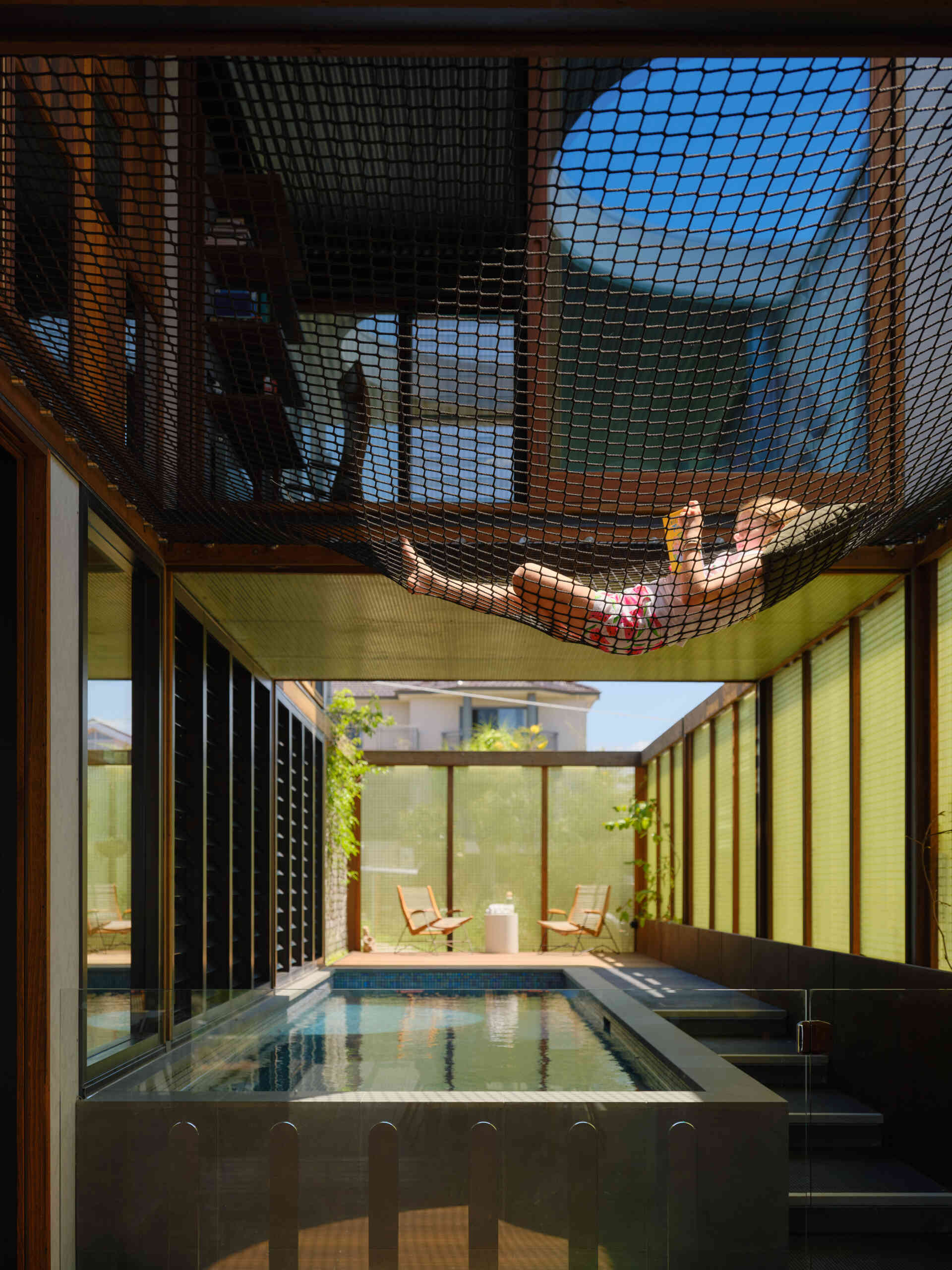 A suspended cargo net above the pool transforms unused airspace into a fun family hangout with incredible views.