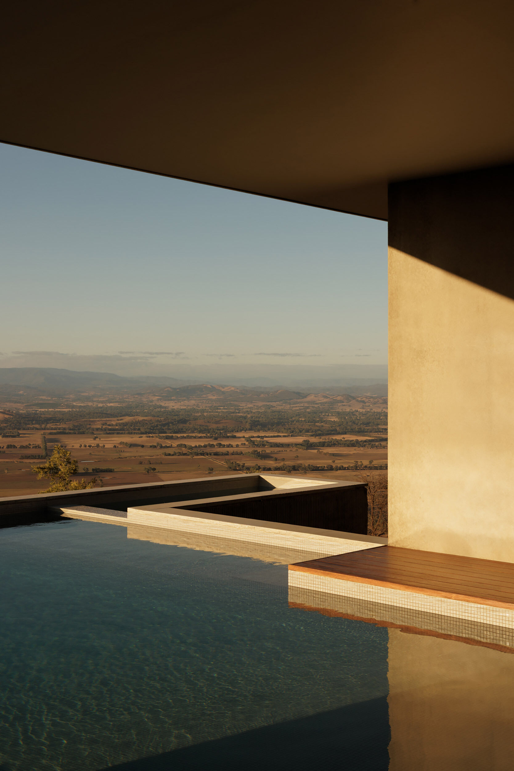 A horizon pool and spa appear to merge with the distant valleys, creating one of the most dramatic viewpoints in the entire home.